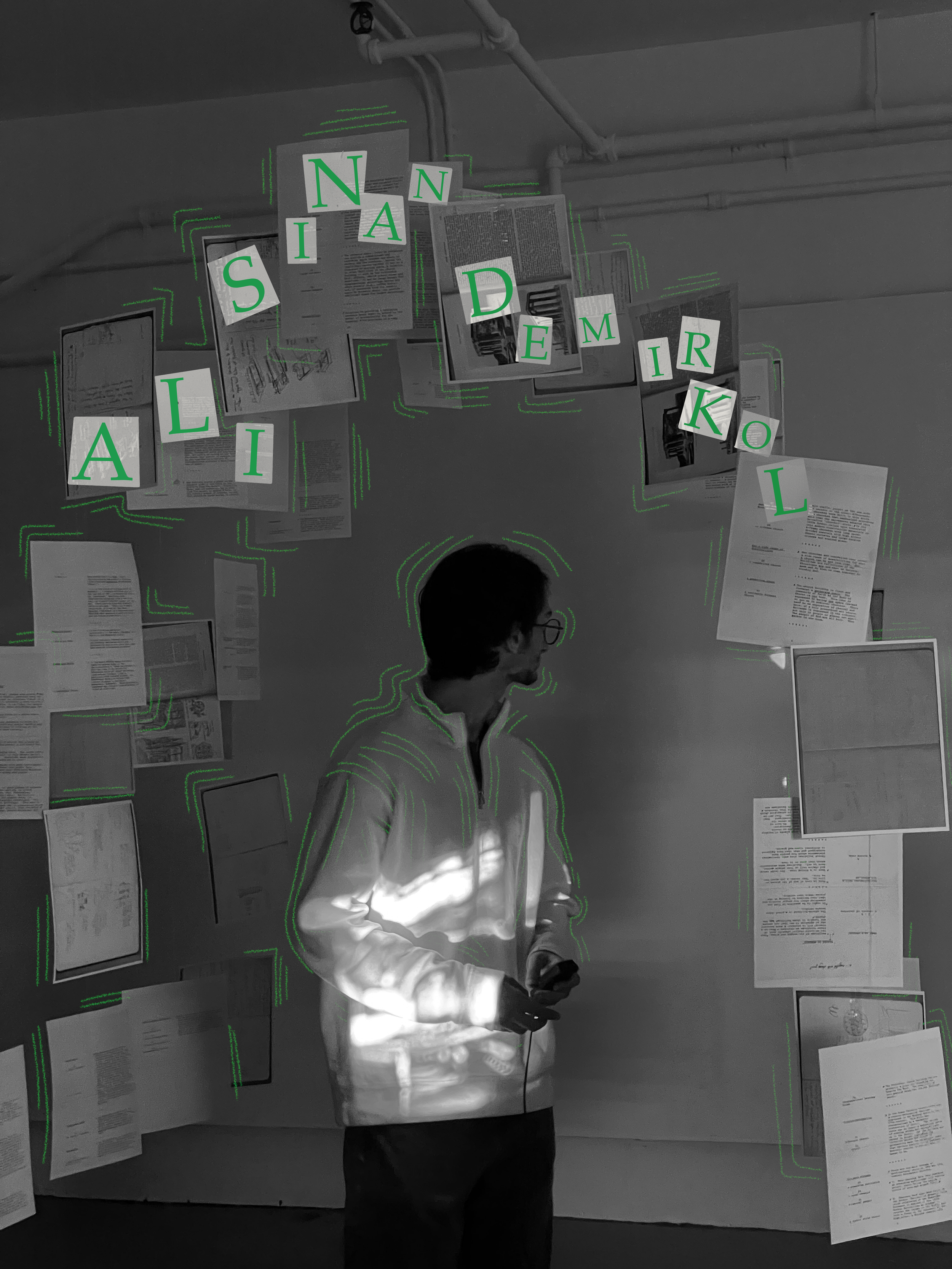 A person standing in front of a wall covered with papers and books, with letters labeled on the images, forming the phrase 'ALI SINAN DEMIRKOL'.