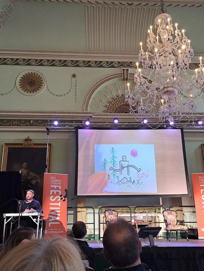 Author Peter Brown at the Bath Children's Literature Festival 2025 doing a live demonstration of drawing Roz the robot from The Wild Robot.