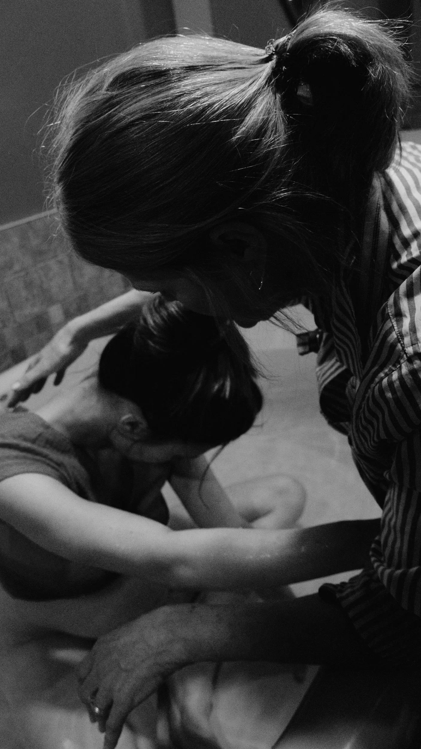 A woman providing physical touch to a woman in active labour.