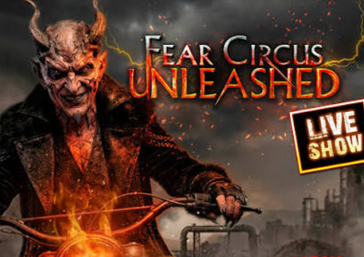 A promotional poster for 'Fear Circus Unleashed' featuring a devil-like figure with horns and a sinister expression riding a motorcycle amidst fire and lightning, advertising a live show.