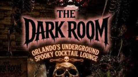 Sign for The Dark Room, Orlando's underground spooky cocktail lounge, with a skull and dark themed decorations.
