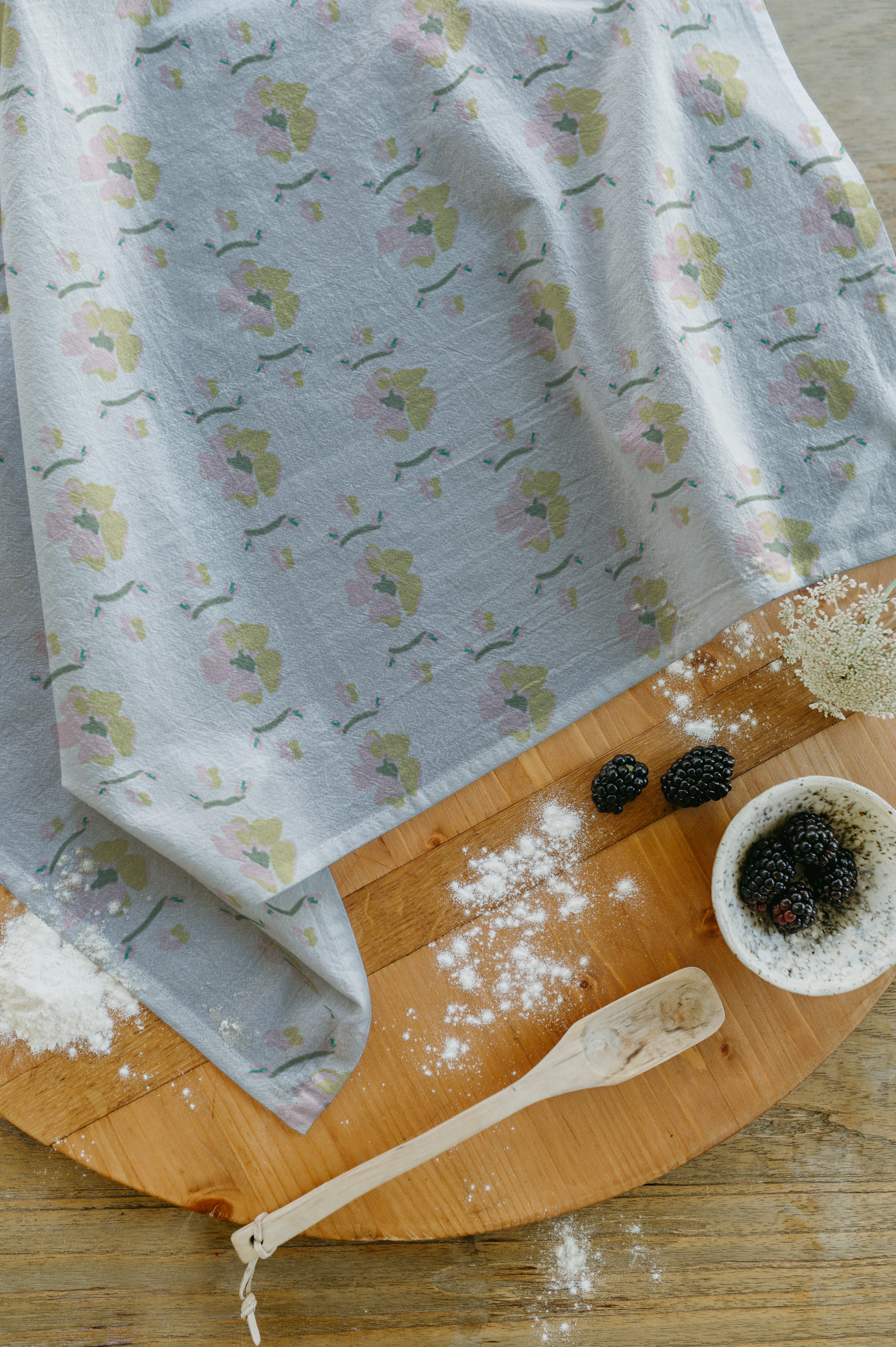 Charcuterie board and floral tea towel.