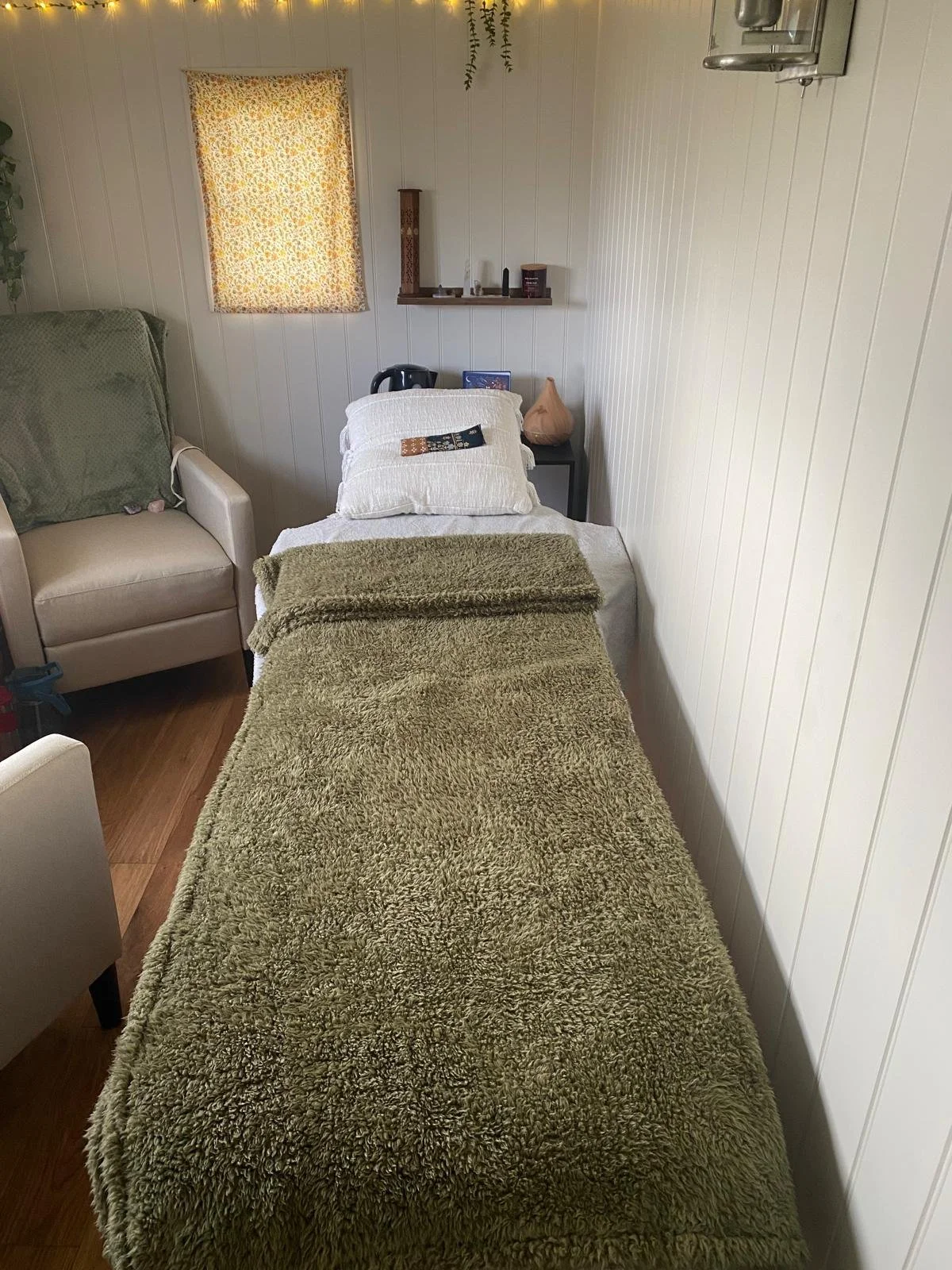 Inside the shepherds hut there is a therapy bed, made up with a blanket and lavender eye pillow. It looks very comfy 