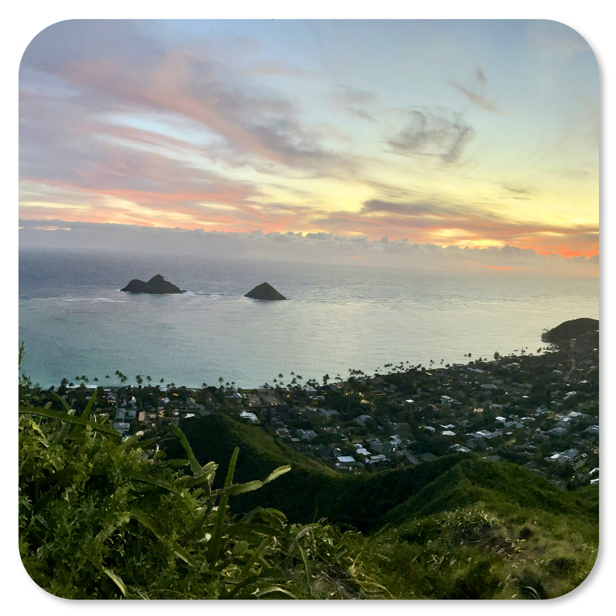 Sunrise from the Lanikai Pillbox Trail with views of the Mokulua Islands and Windward Oahu.