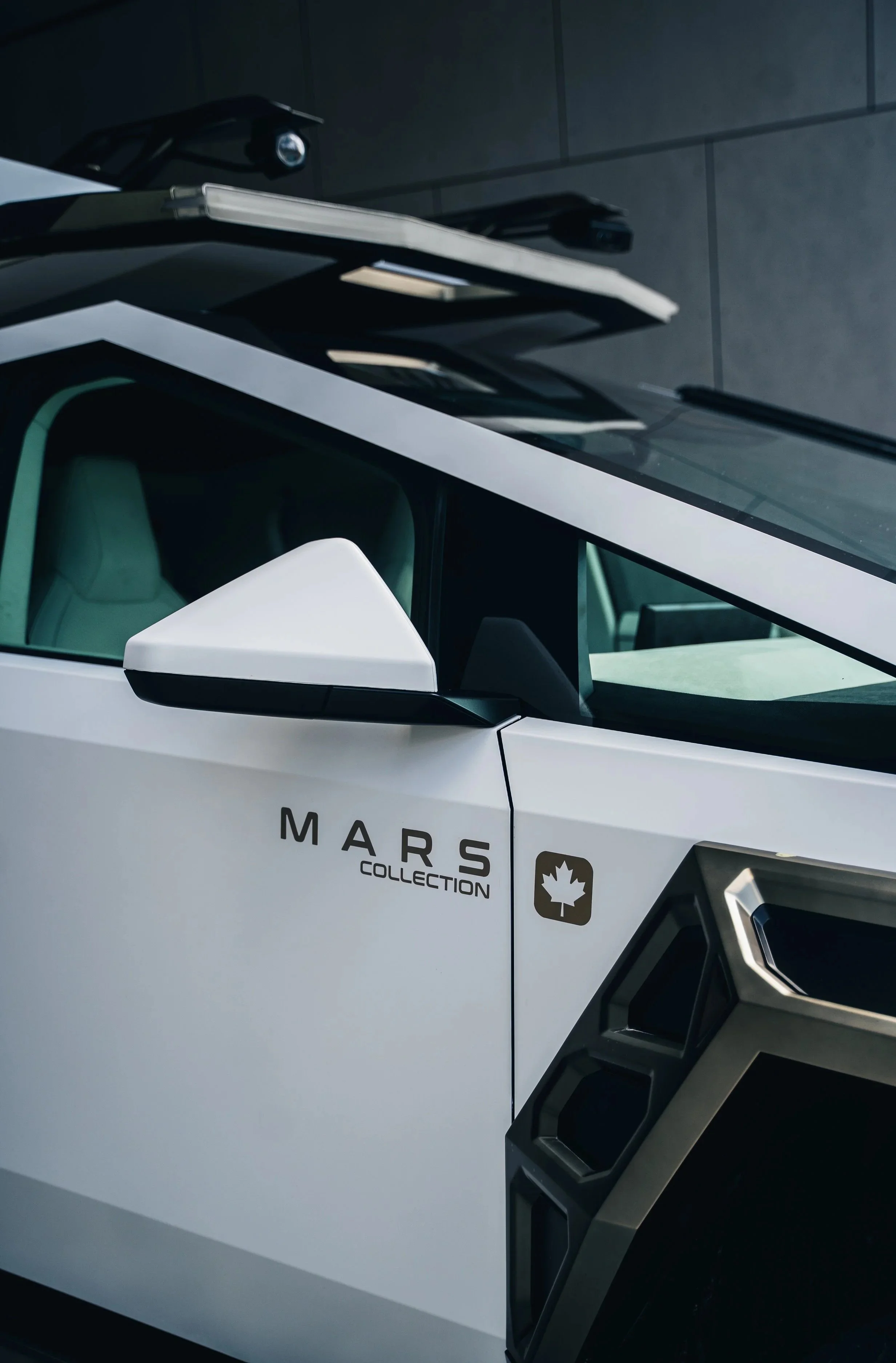 Close-up of a white vehicle from the Mars Collection, with a Canadian maple leaf logo on the side.