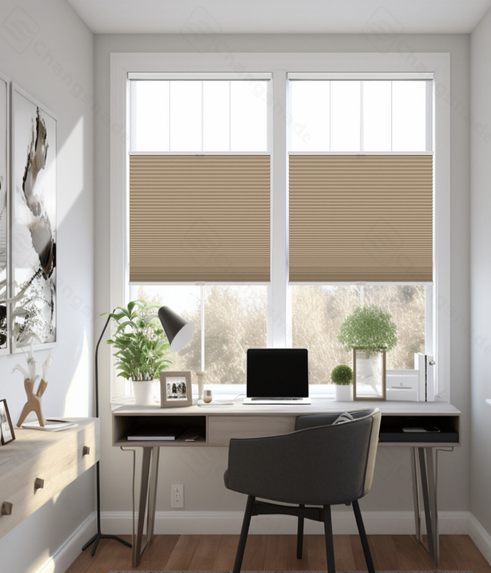 Home office with a large window, beige shades, a white desk with a black monitor, and two potted plants.