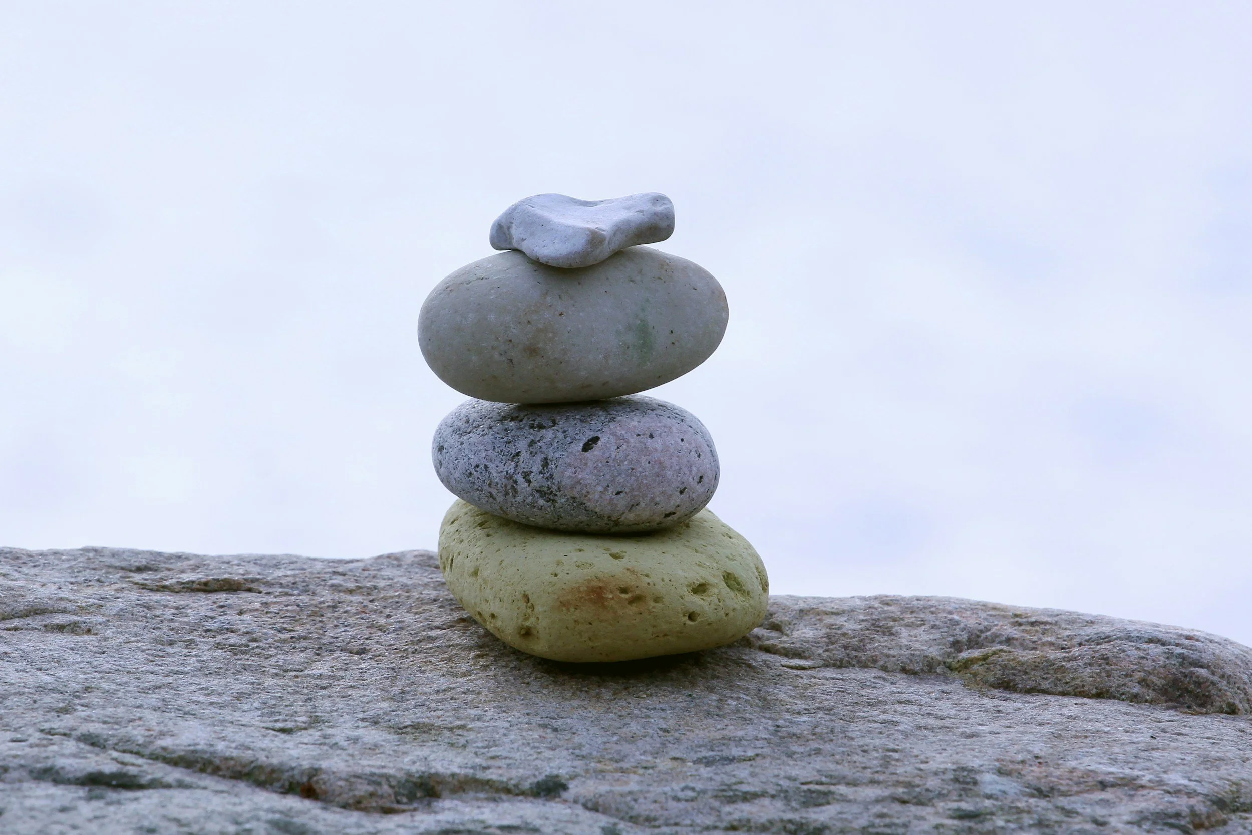 4 stacked rocks on larger rock