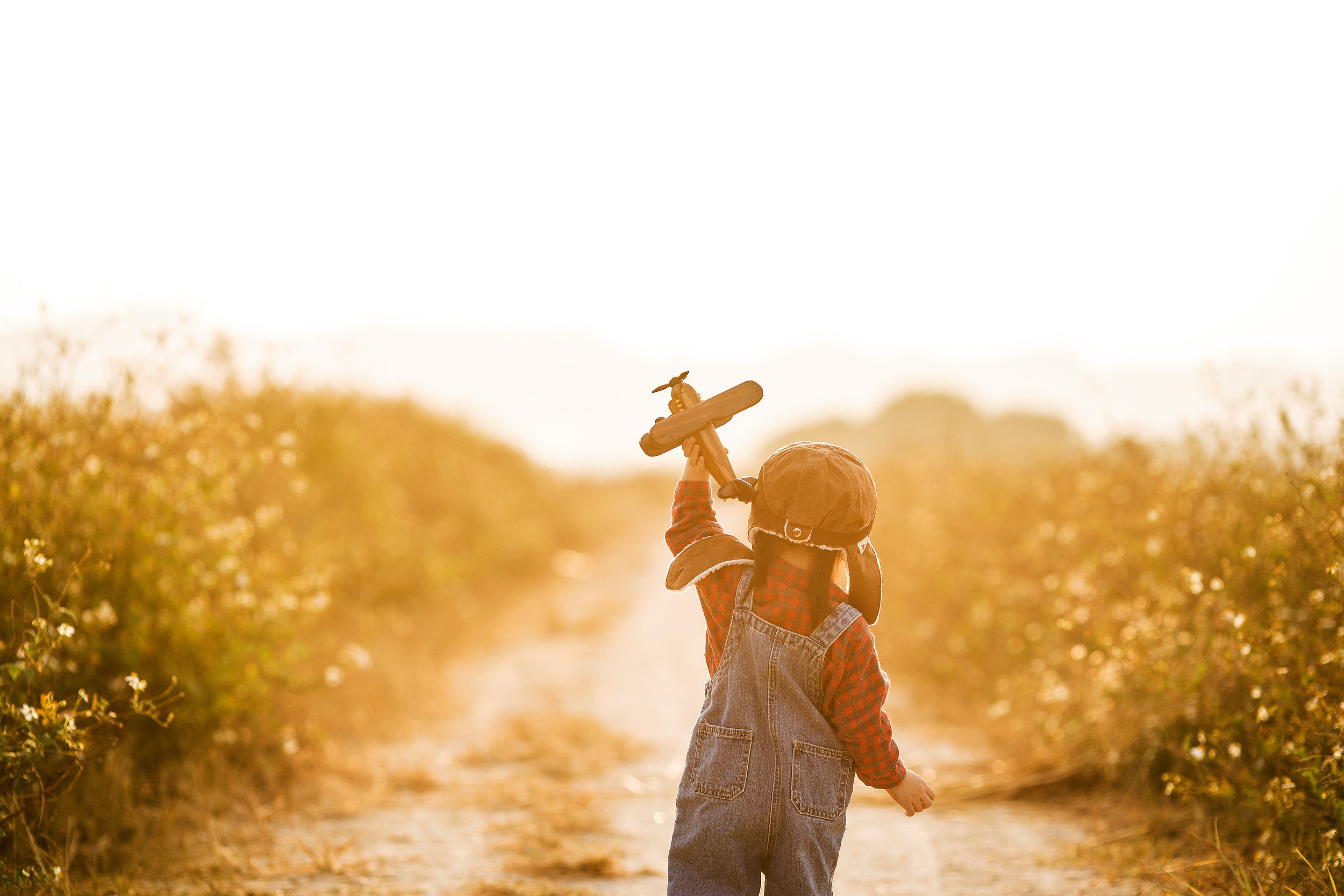 Child holding toy plane