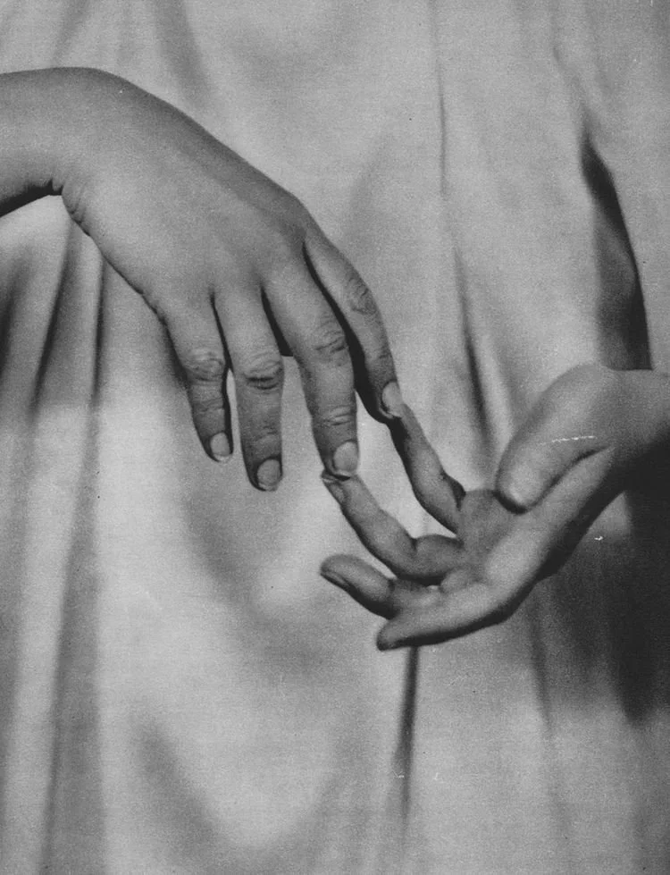 Two hands with intertwining pinky fingers, symbolizing connection or friendship.