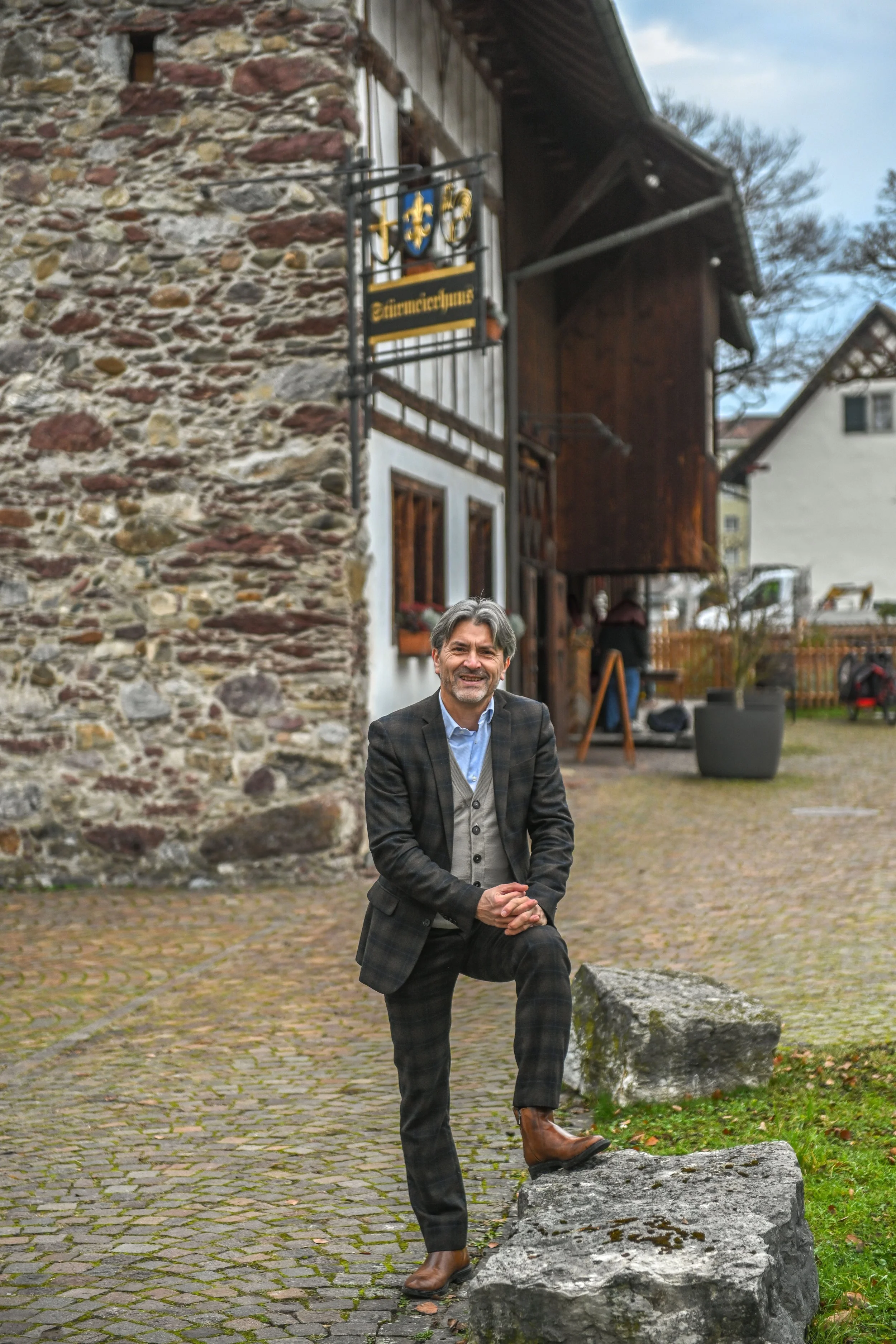 Stadtpräsident Markus Bärtschiger steht lächelnd vor dem Stürmeierhaus in Schlieren.