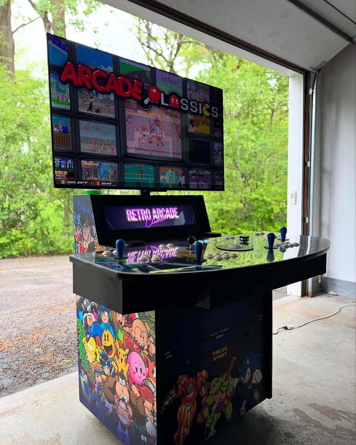 A fighting arcade game machine with a colorful screen, control buttons, and joysticks, featuring characters and the phrase 'Let's Fight' displayed on the top.