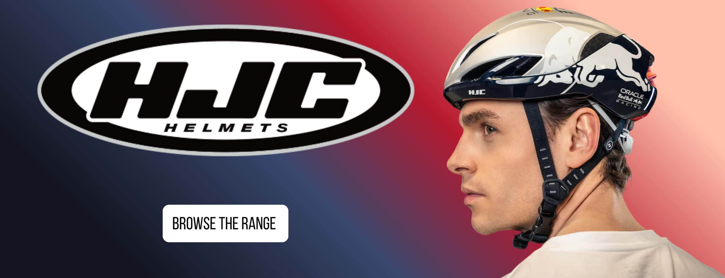 Side profile of a man wearing a white and blue bicycle helmet with branding for Red Bull Racing and Oracle, against a background with a gradient from navy blue on the left to light pink on the right, with a black and white HJC Helmets logo and a whit