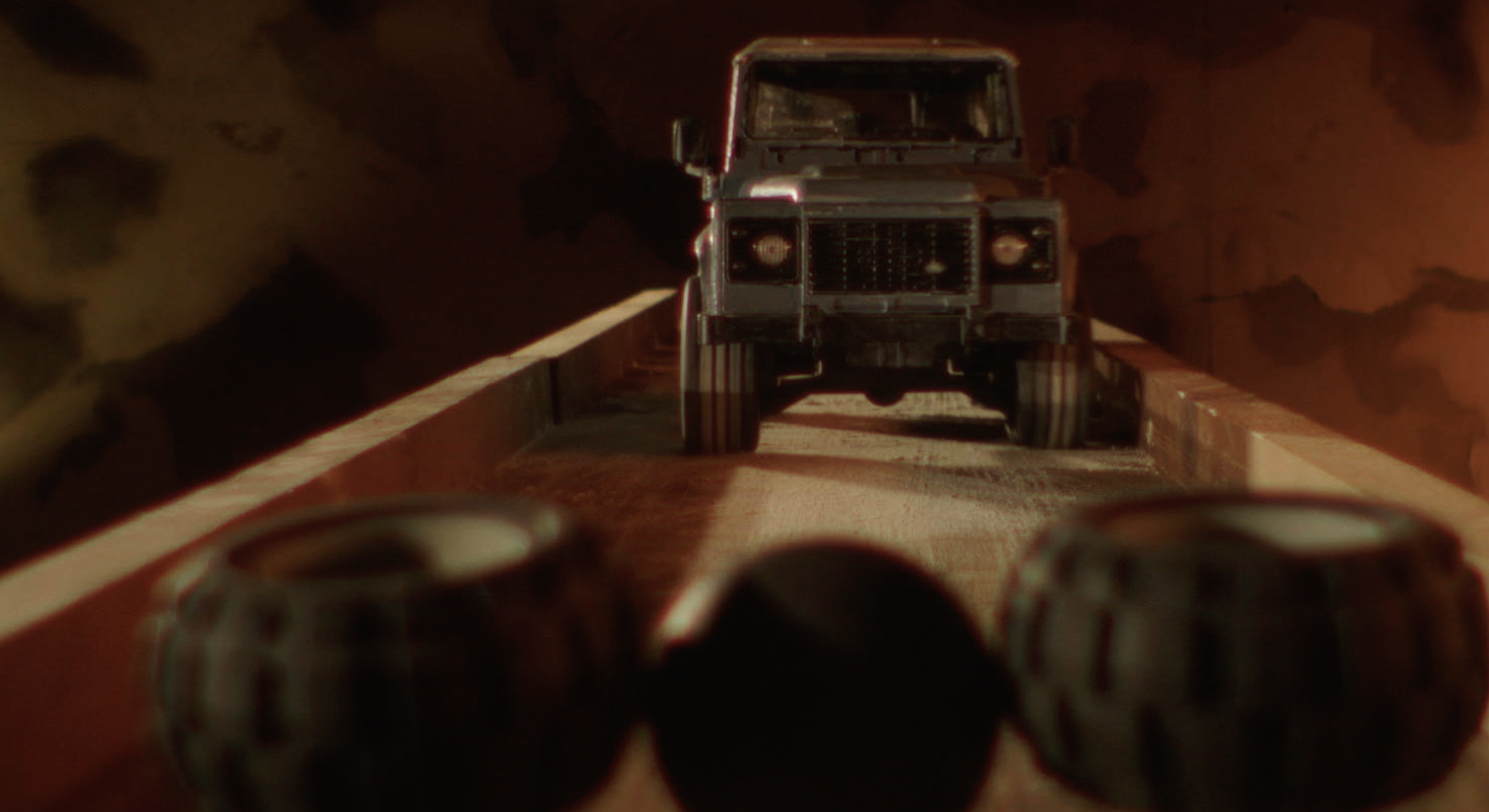 A toy car driving on a wood ramp.