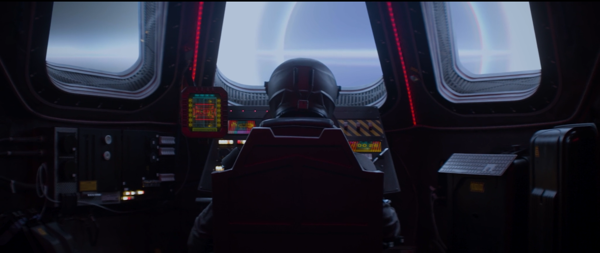 A person in a spacesuit sitting at a control panel inside a spaceship, looking out of a large window showing a view of a large anomaly from space.