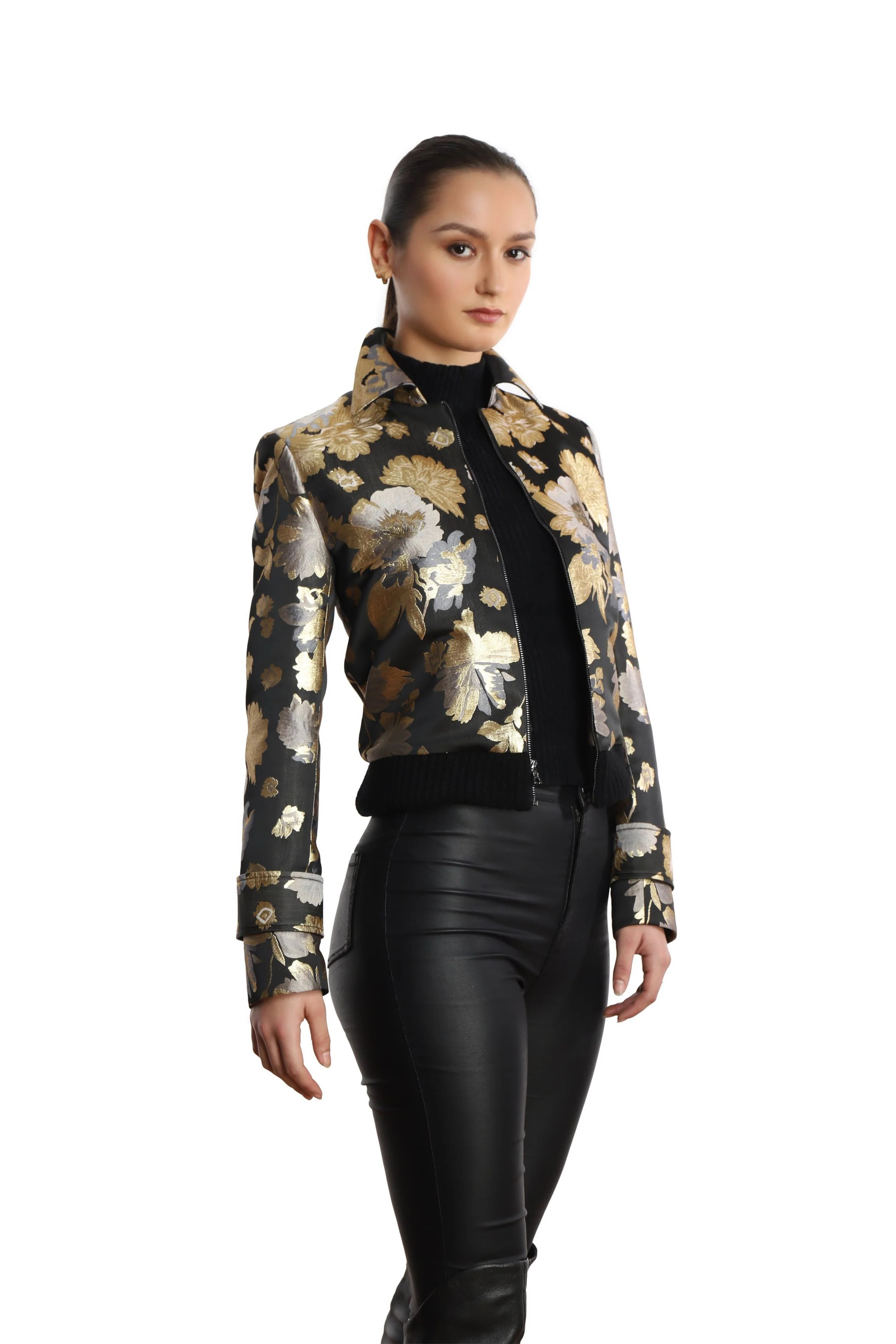 Close up of model wearing a metallic silver, gold and black jacket with leather-like leggings.