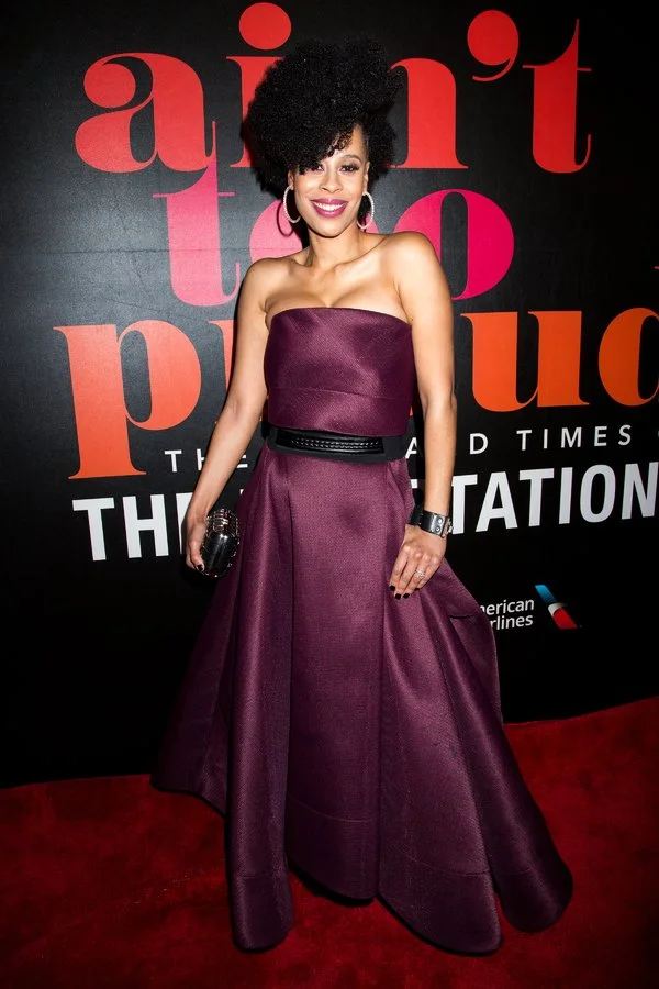 Dominique Morriseau on red carpet at Broadway premier wearing a plum dress, styled by Chandra Moore.