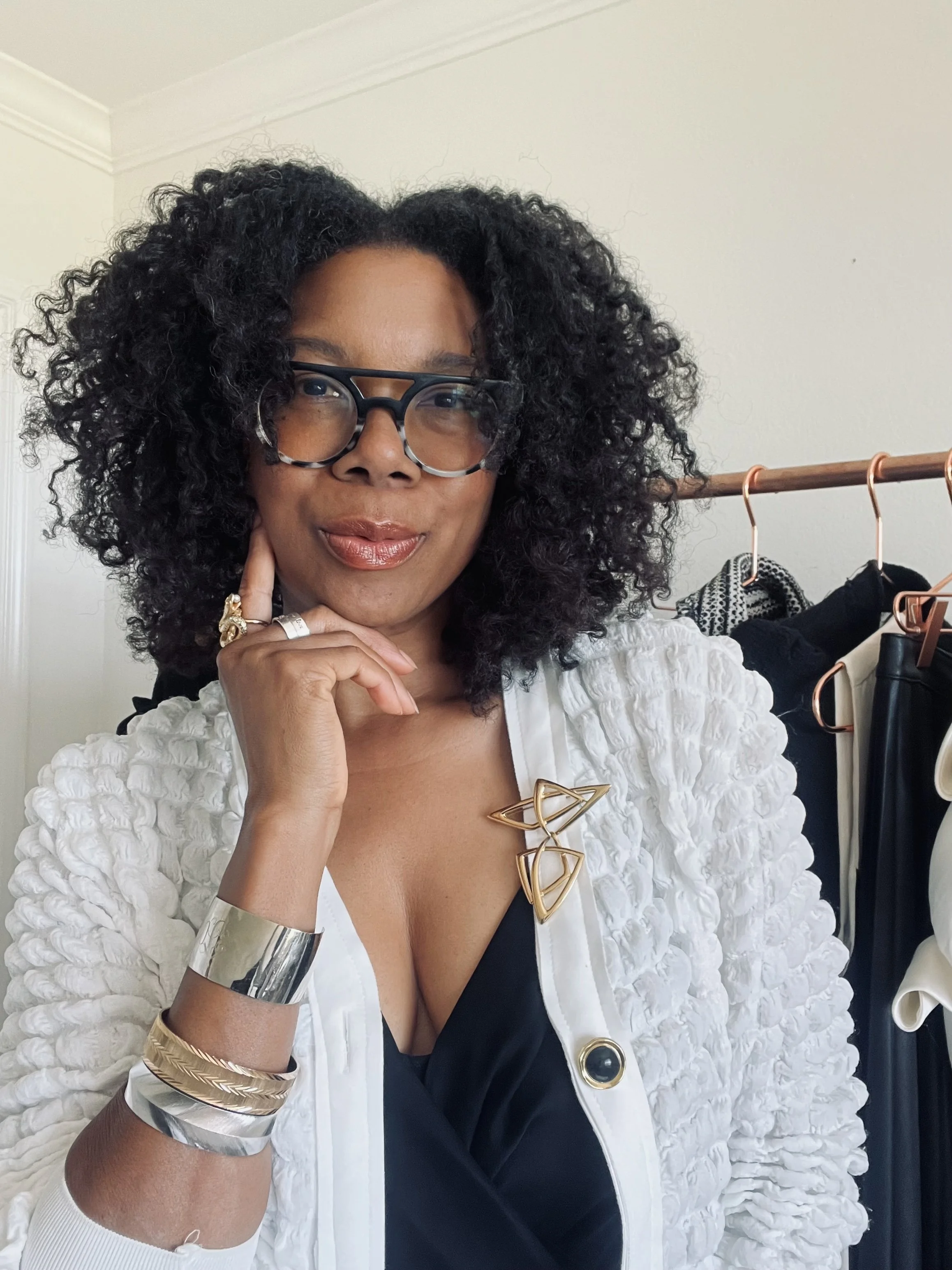 Curated wardrobe pieces on a clothing rack for a client's styling session.,by personal and fashion stylist Chandra Moore.
