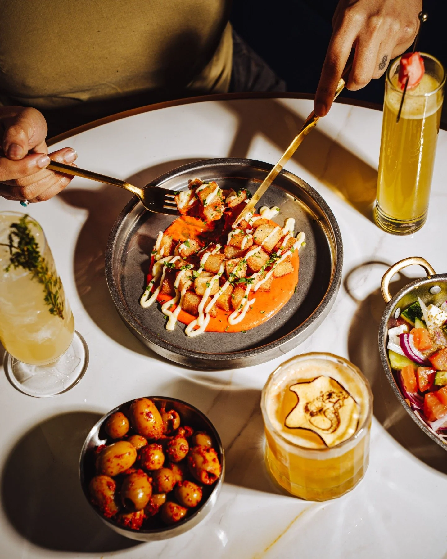 Golden, crispy, and impossible to leave untouched.

Our Patatas Bravas are the kind of table starter that quickly becomes everyone's favorite dish. Crisp fried potatoes, rich brava sauce, garlic aioli, and our house spice mix come together for the pe