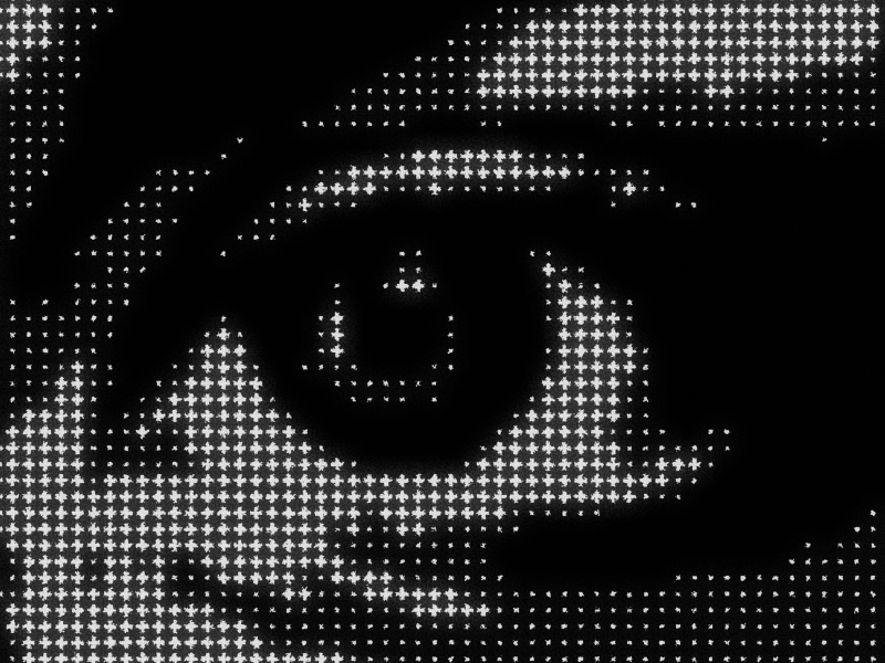 Halftone cross pattern effect applied to eye photograph