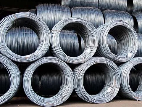 Stacks of large metal wire coils arranged in rows.