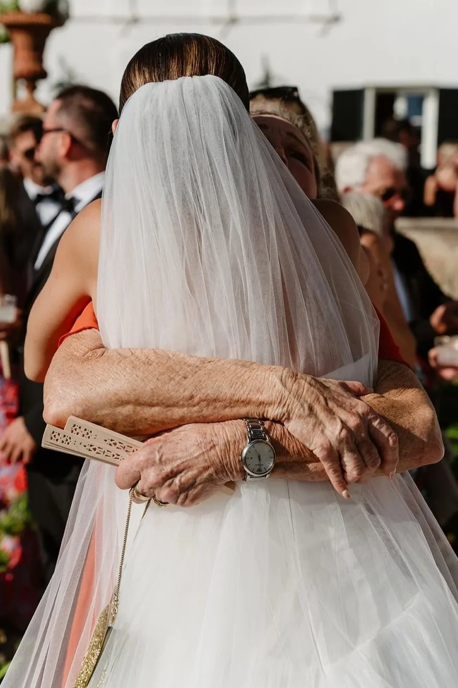 Bride embracing her grandmother after the ceremony in a deeply emotional moment