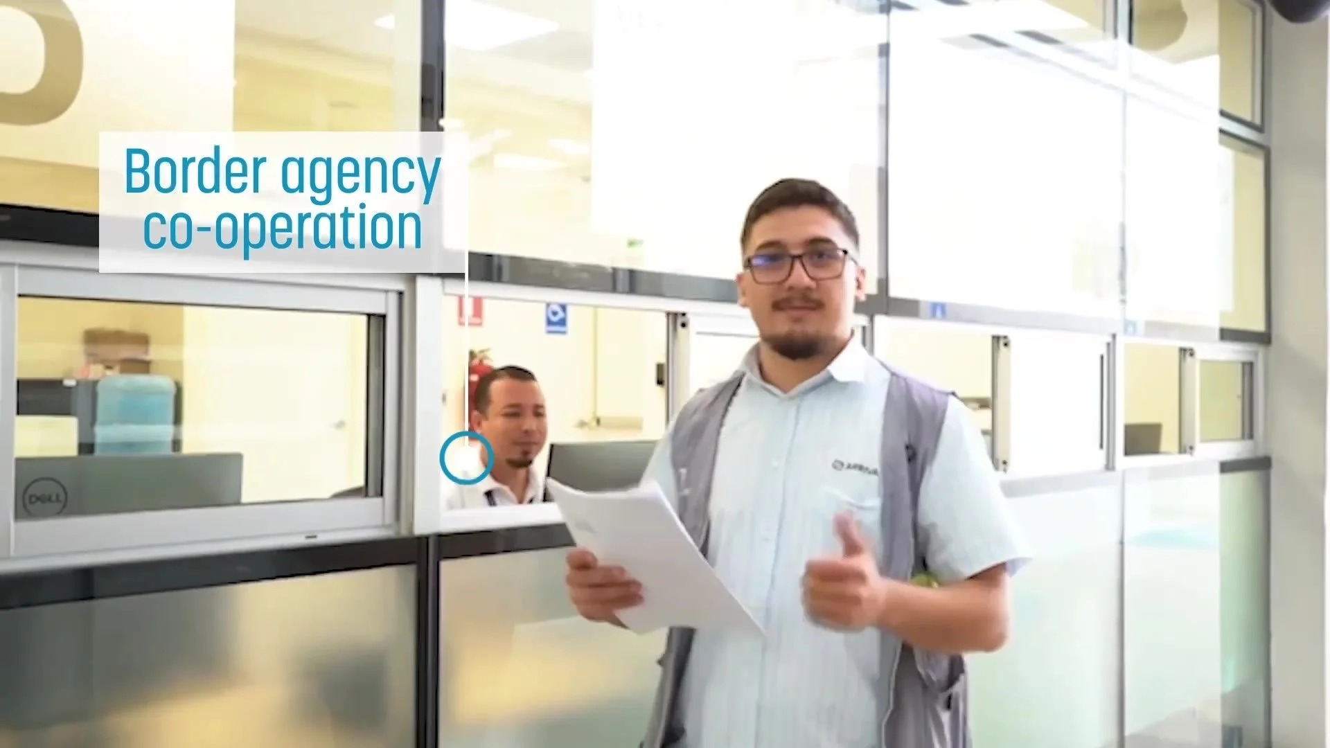 Customs officer with paperwork under a border agency co-operation caption
