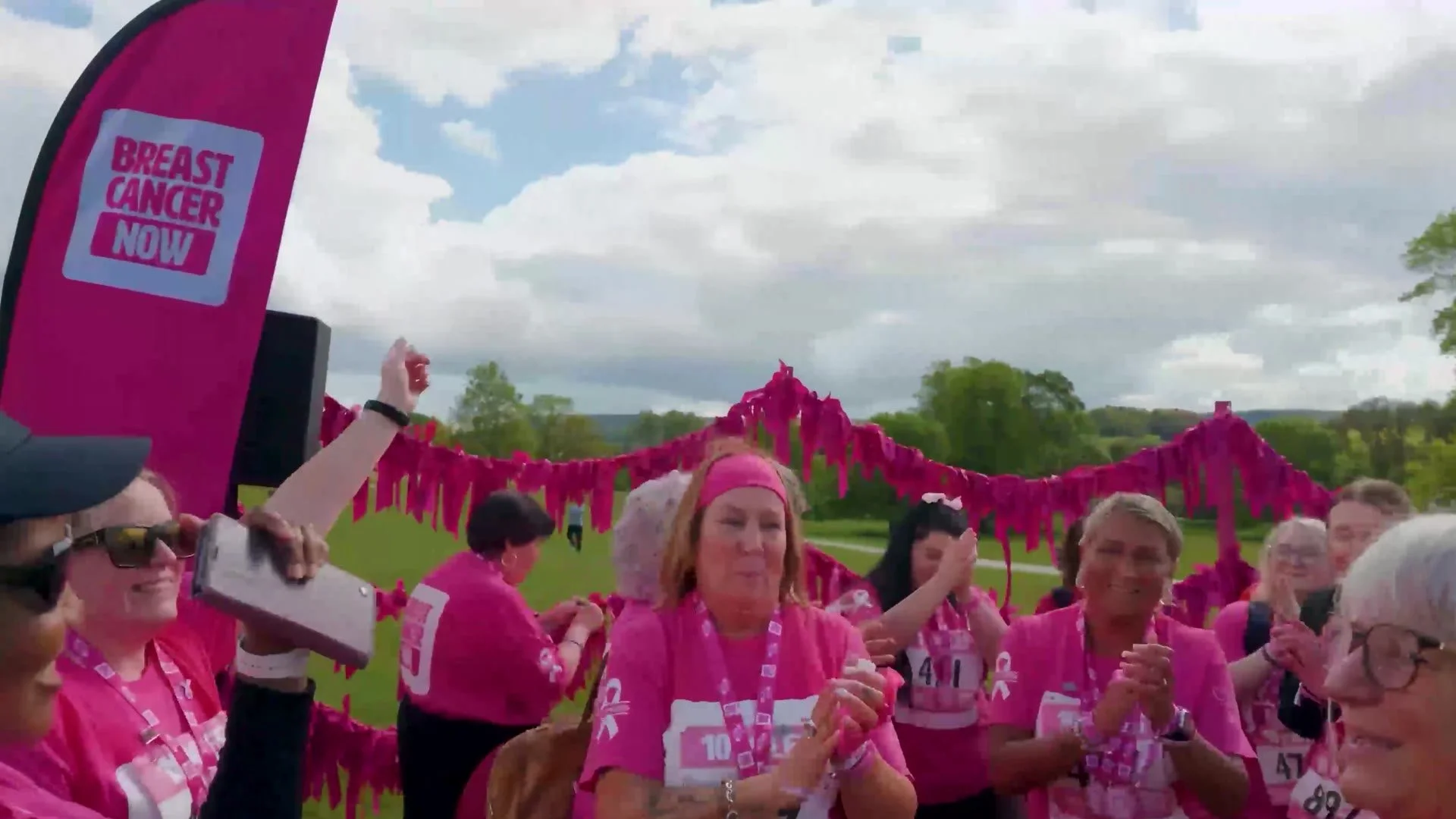Walkers celebrating at the Pink Ribbon Walk finish line