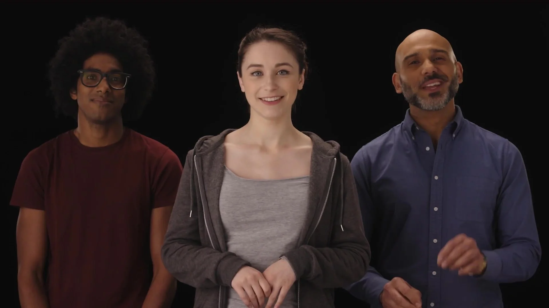 Three presenters on a black set