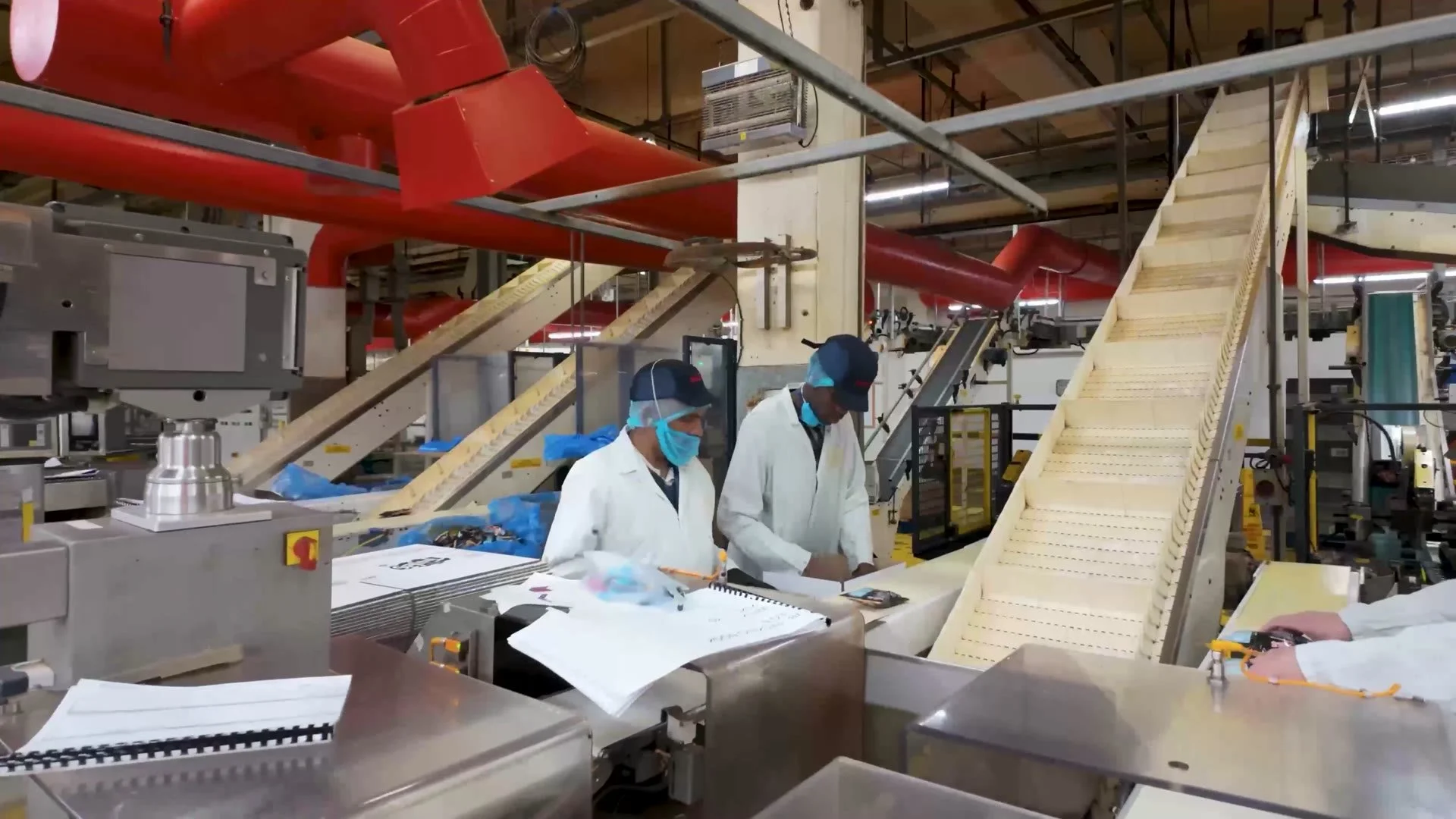 Jacob's colleagues checking product on the line