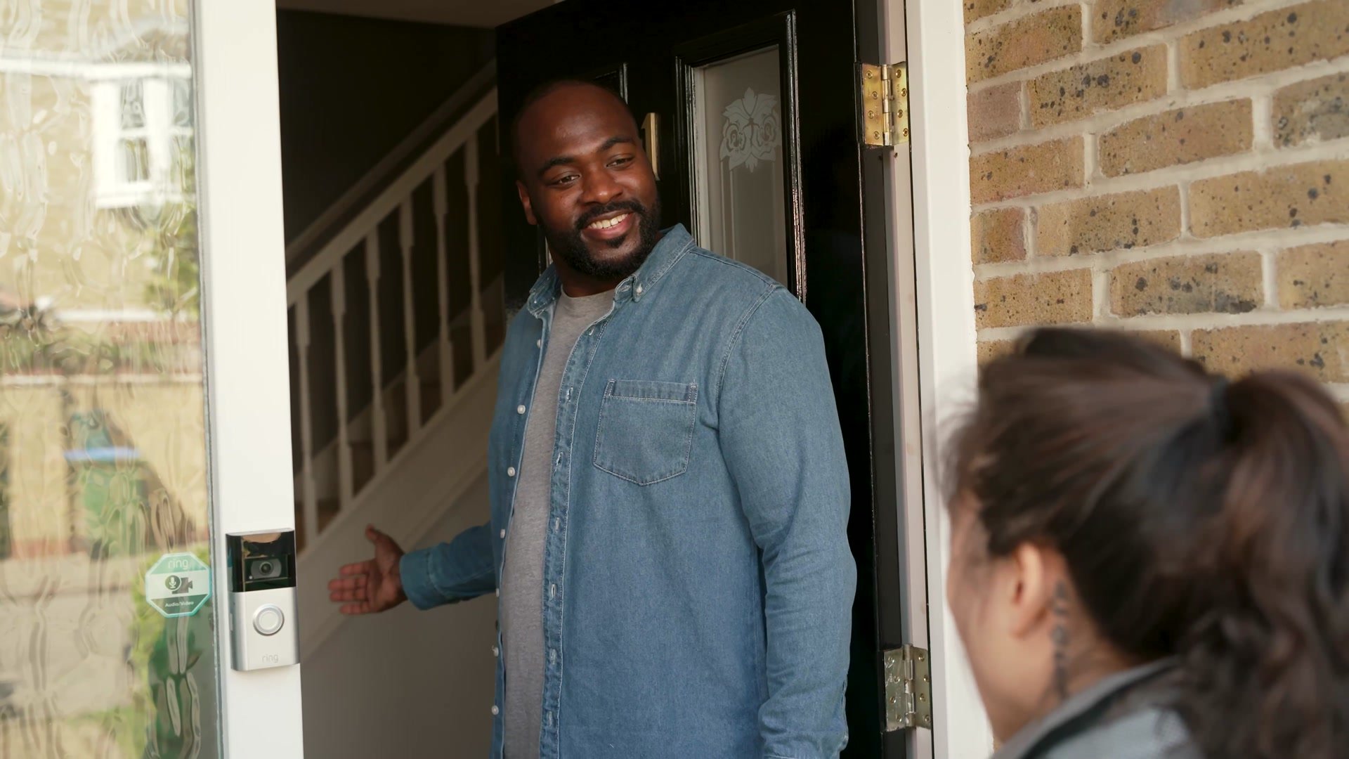Customer answering the door to an Uber Eats courier