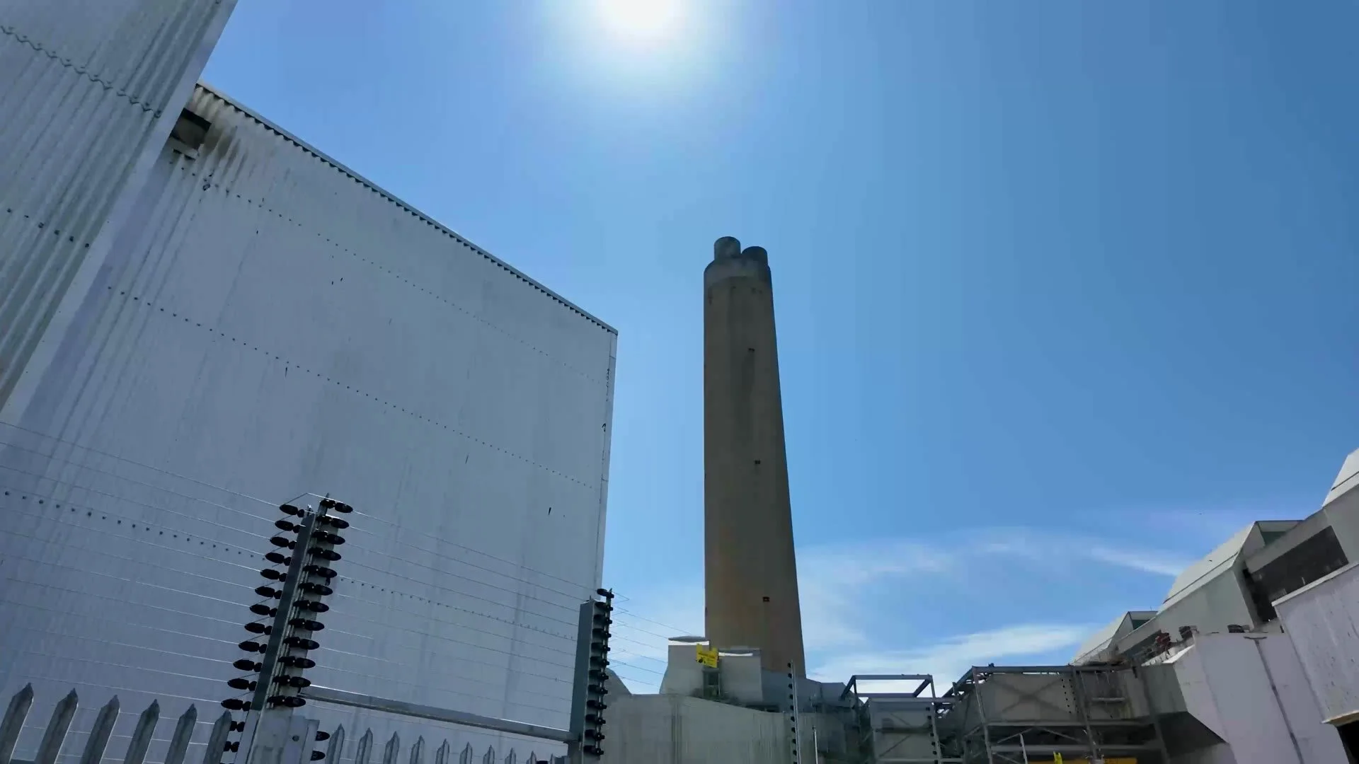Aberthaw Power Station chimney from below against a blue sky