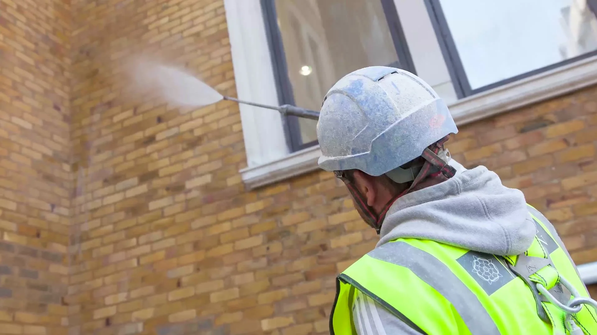 Cleaning a brick facade on site