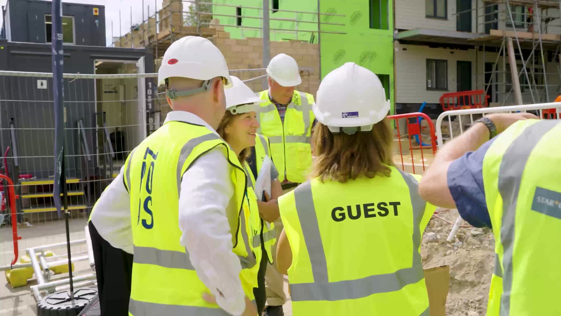 Visitors touring the site in hard hats
