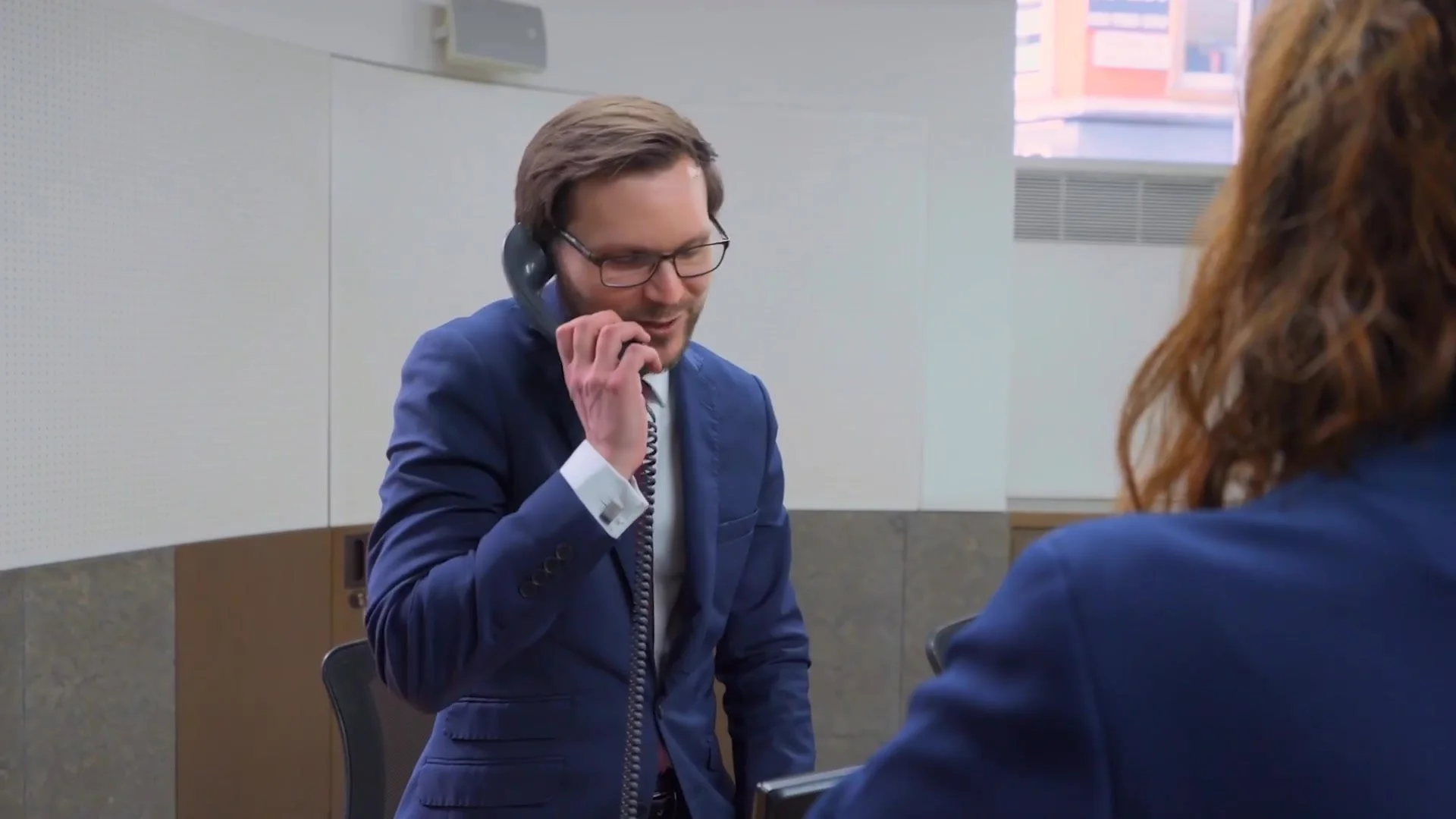 A team member on the phone at a reception desk