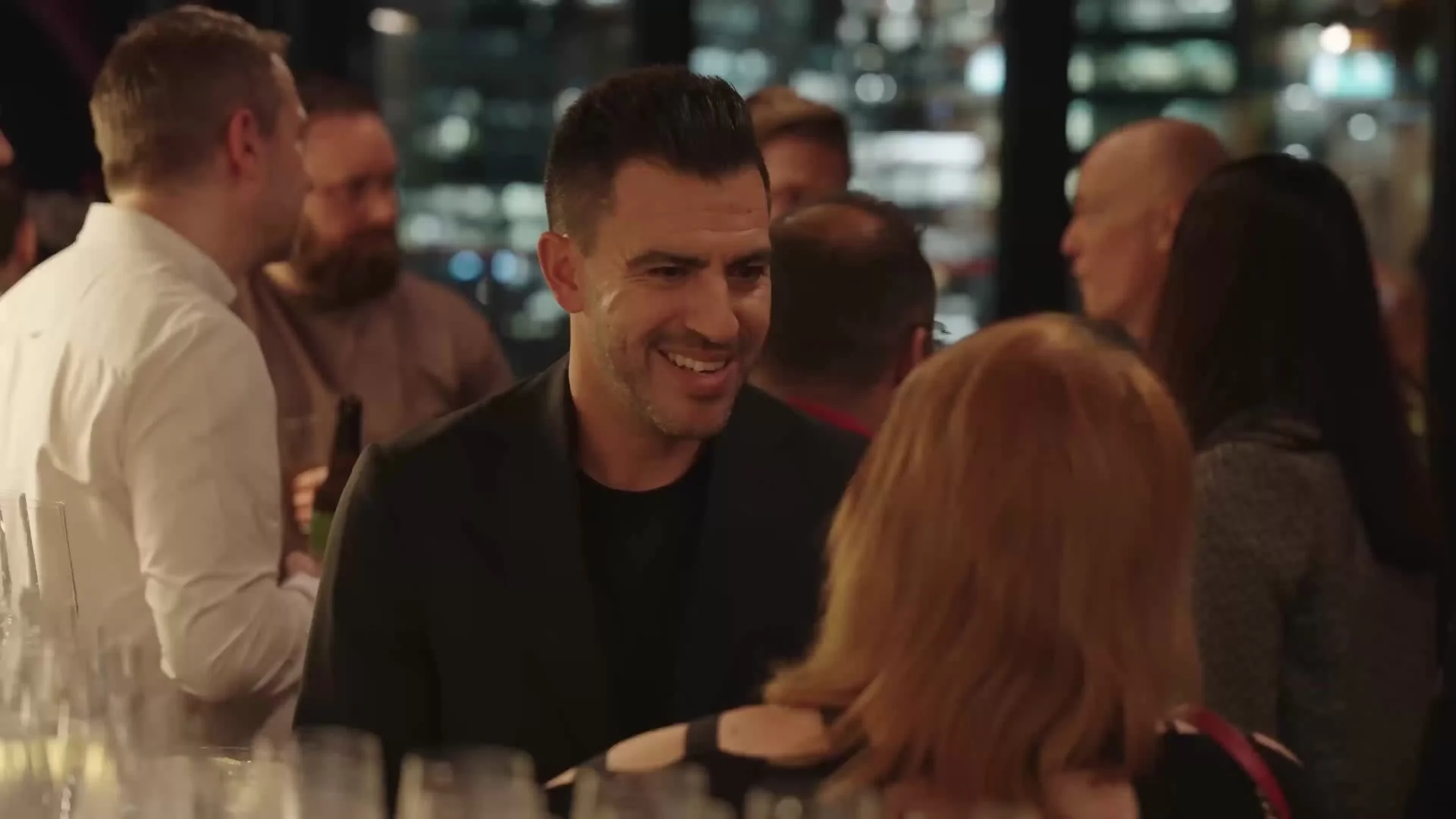 Guests networking at the bar