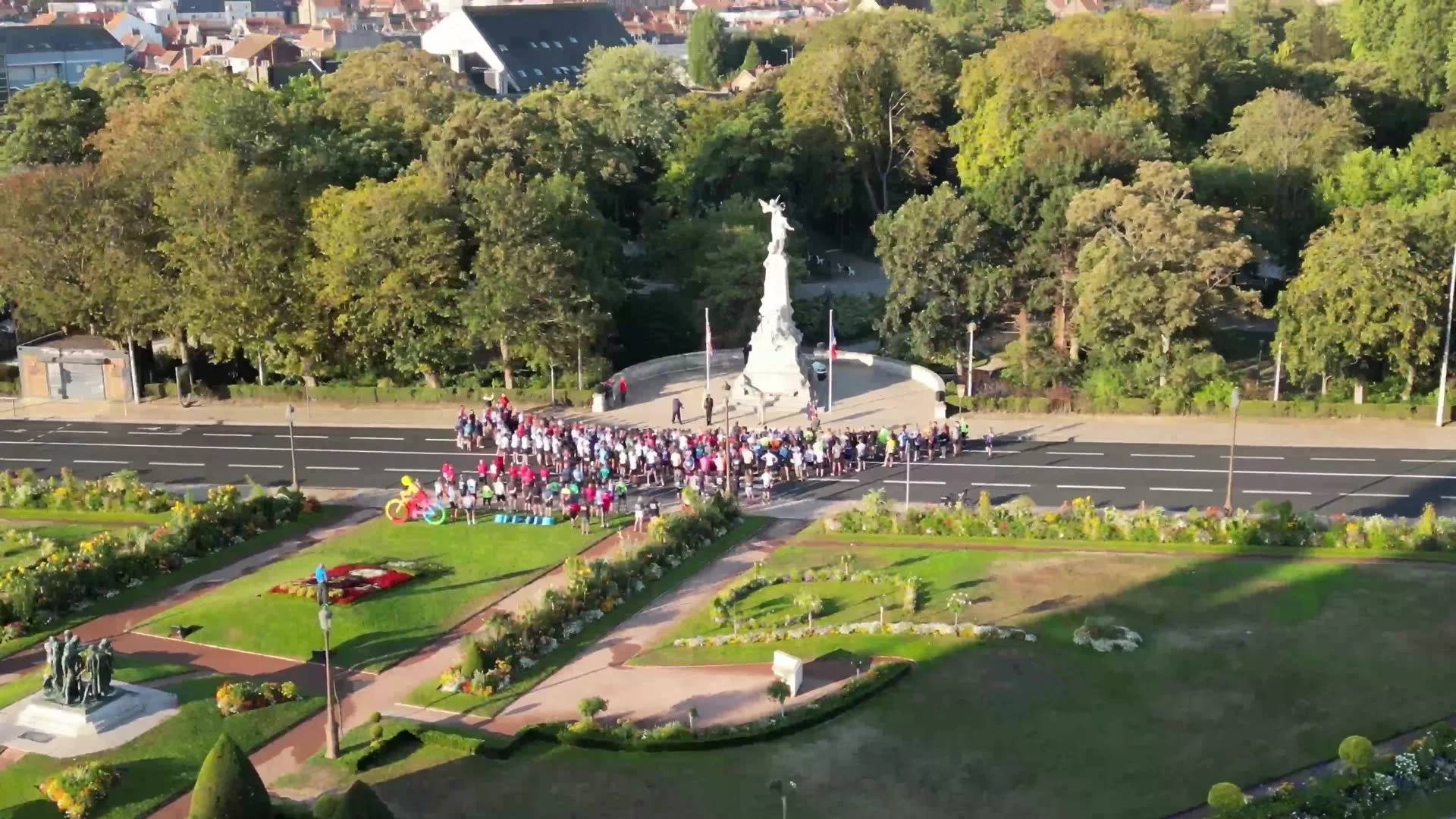 Riders gathered at a memorial, seen from above