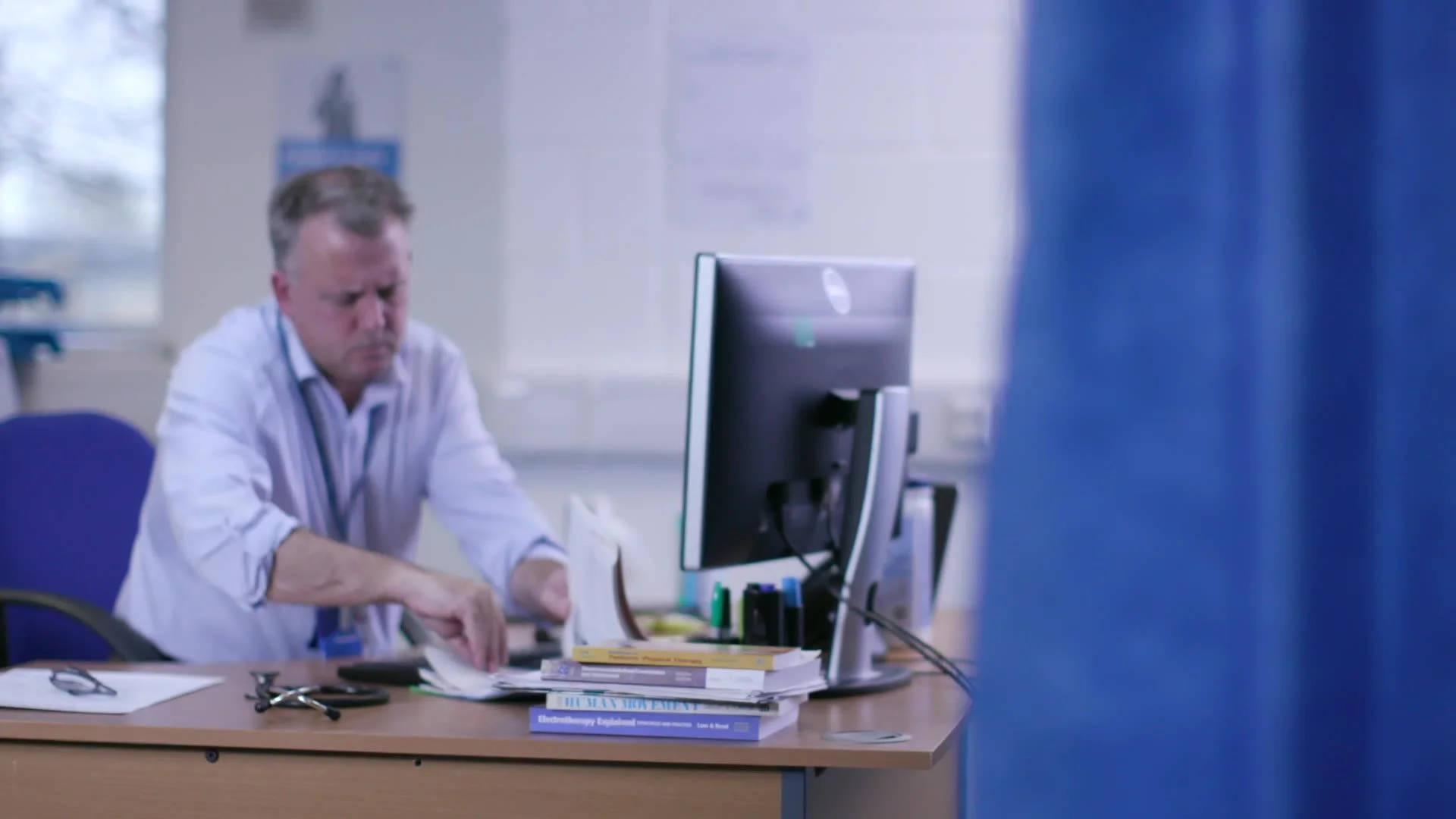 A clinician working at his desk