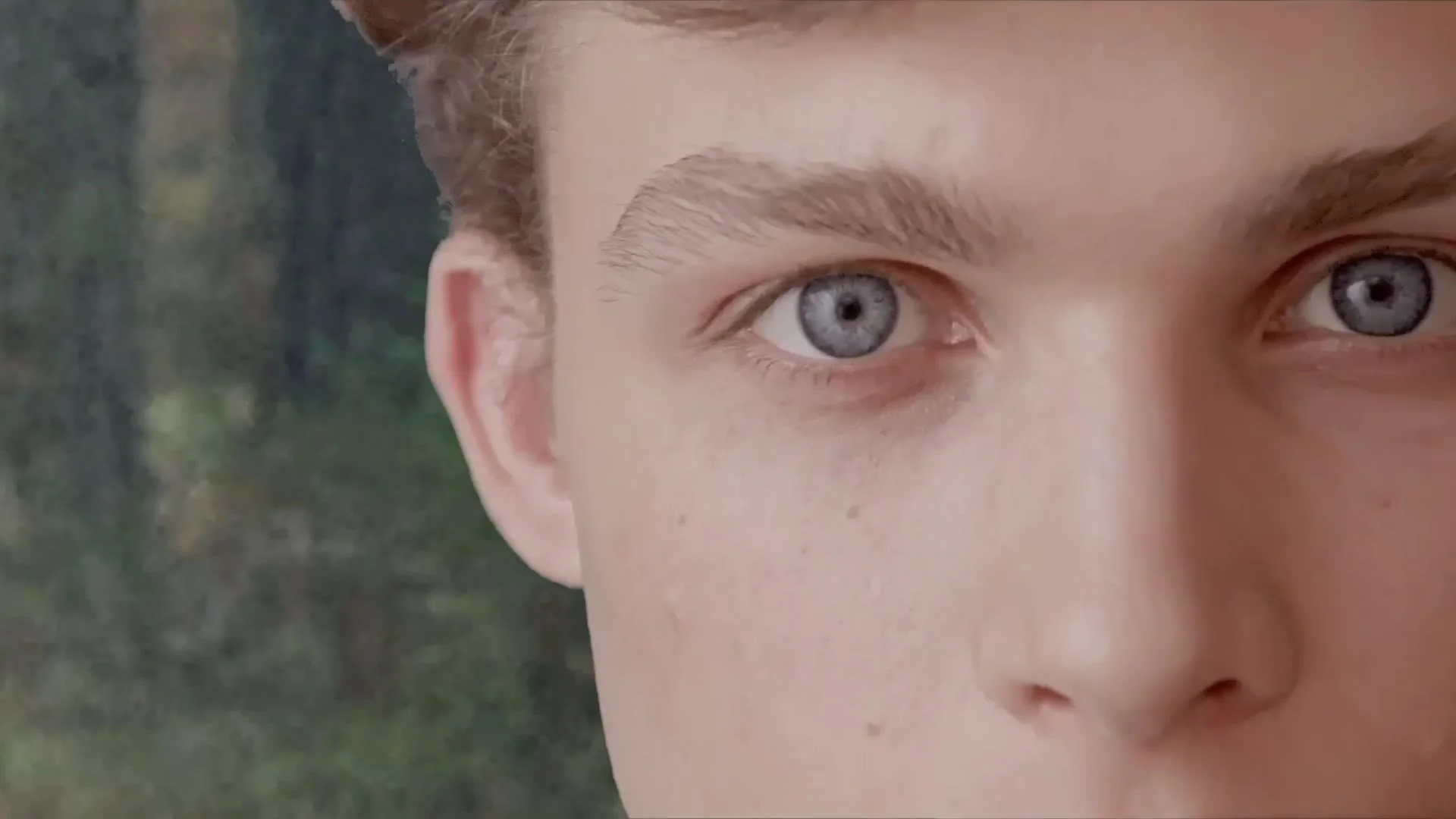 Close-up of an actor in the forest setting