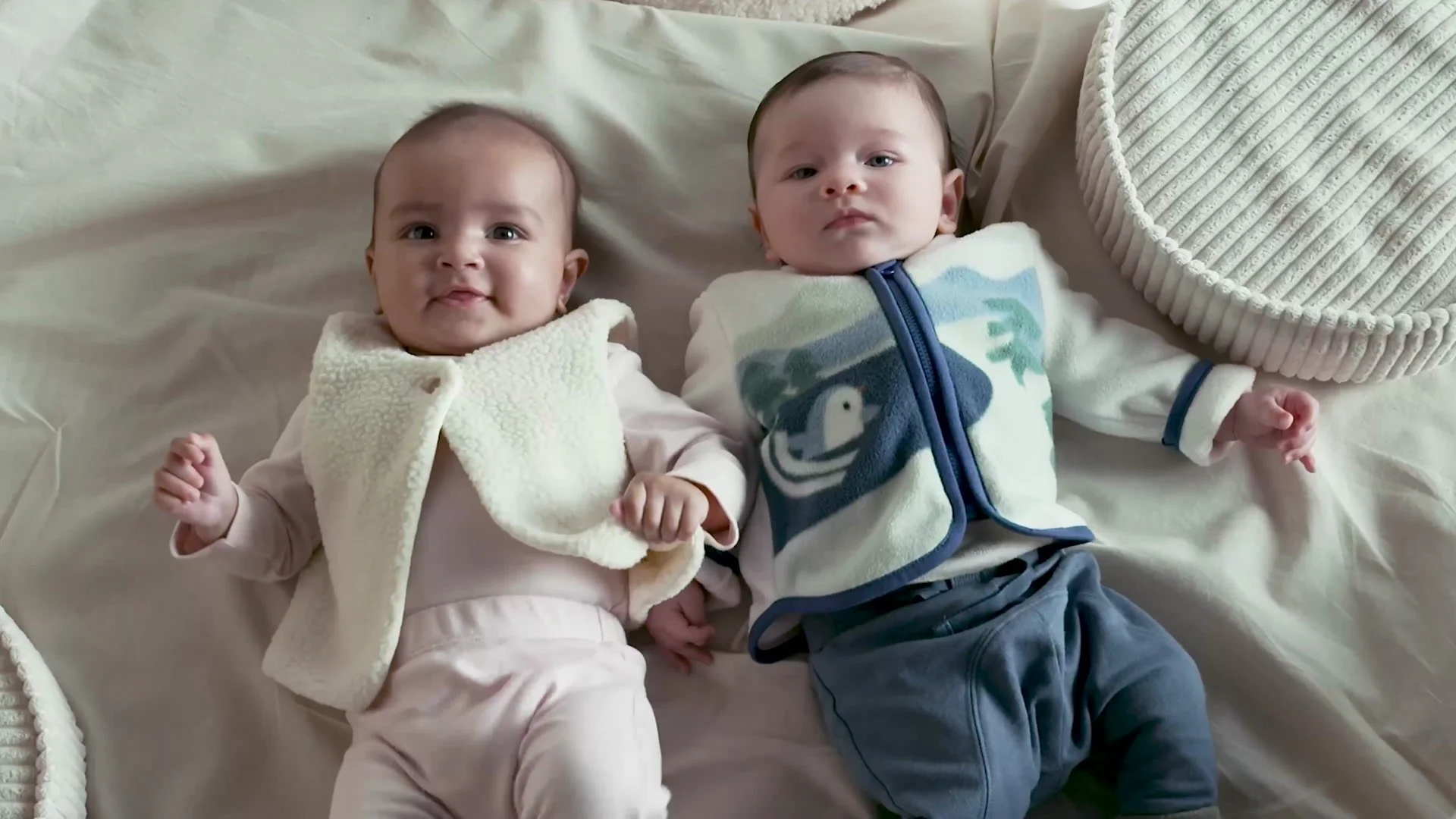 Two babies in sleepwear on soft bedding, from Mothercare Playful Days, Cosy Nights