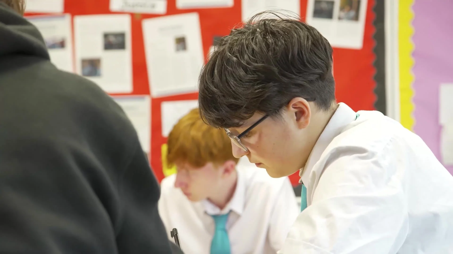 A student writing during a workshop