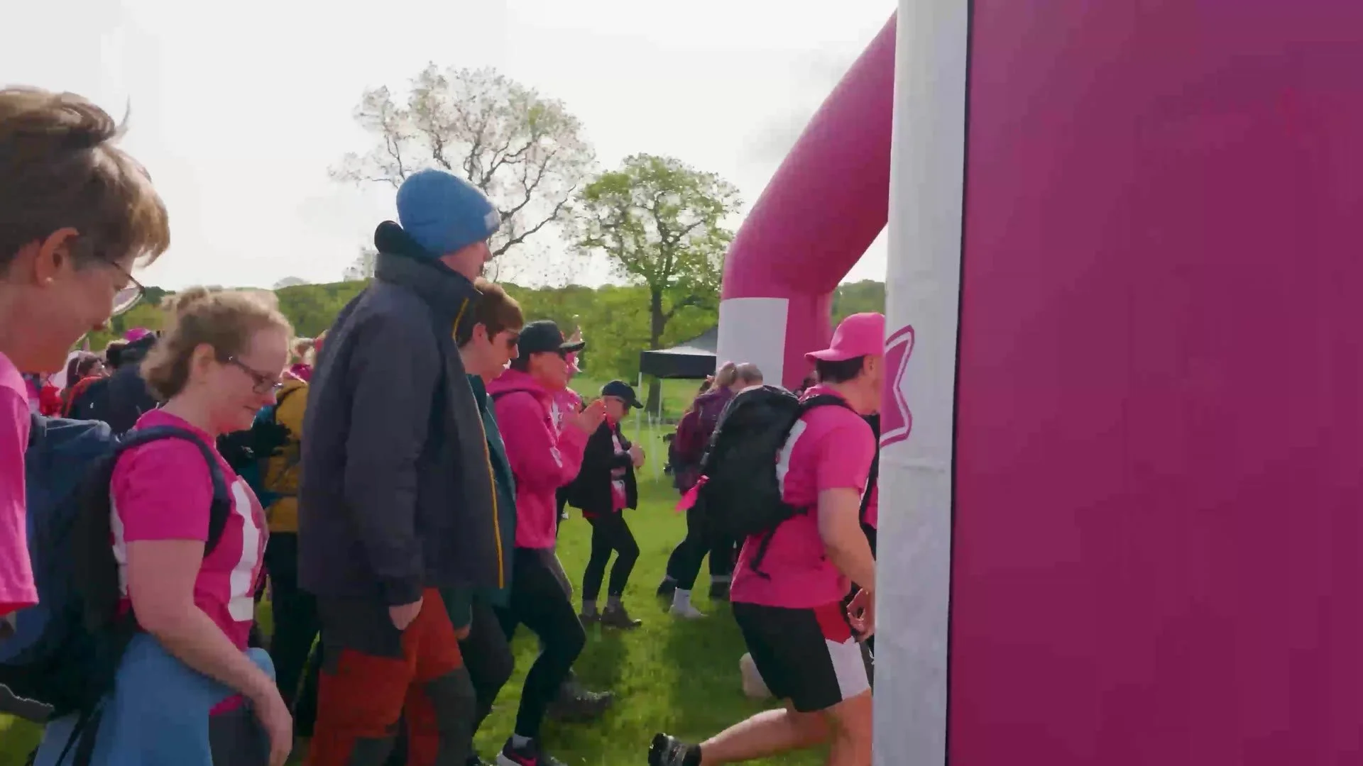 Walkers setting off through the start arch of the Pink Ribbon Walk