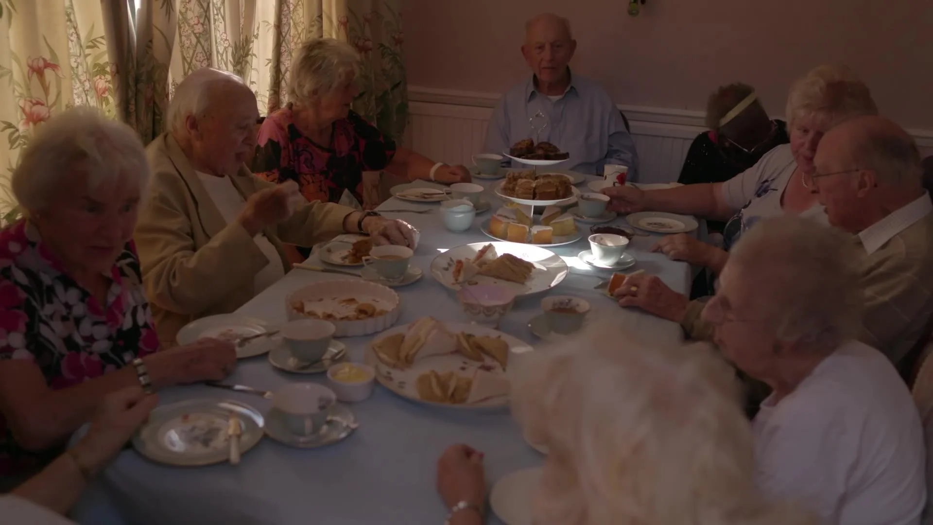 Guests around the table at the monthly tea party
