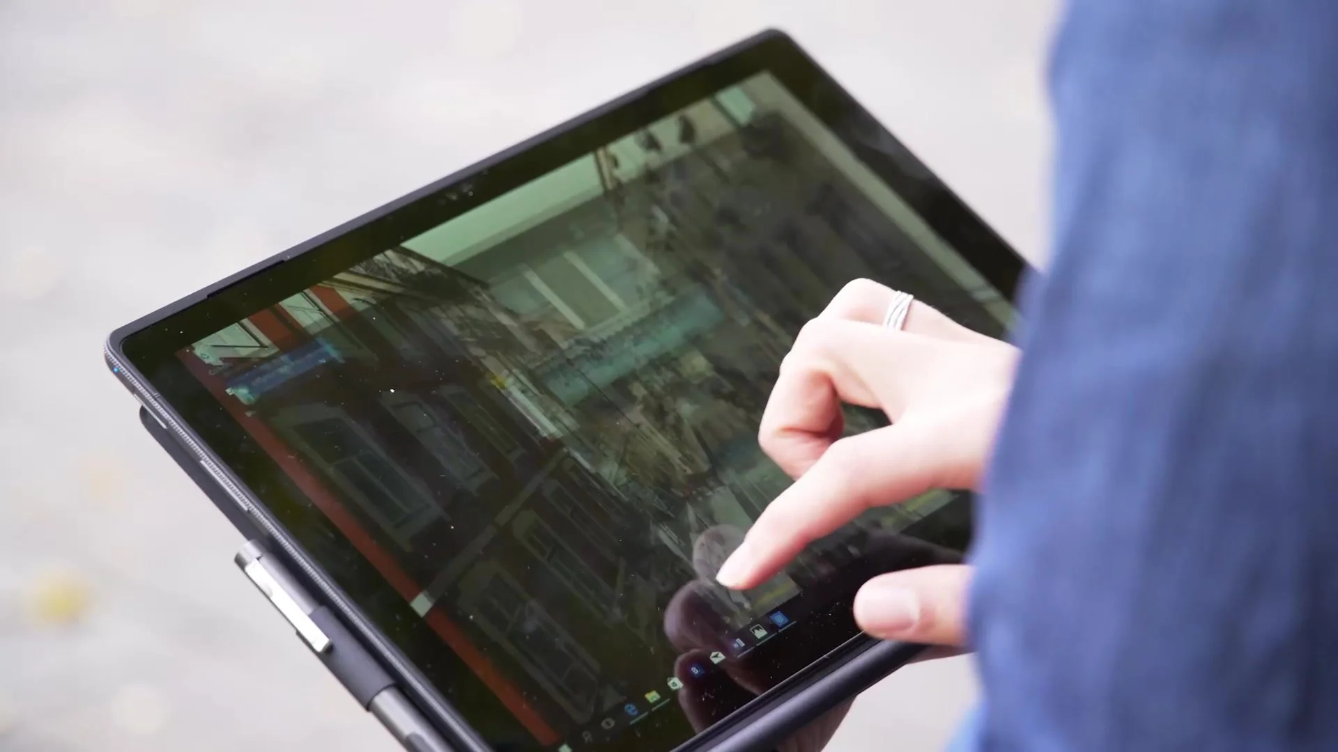 Hand using an Acer convertible laptop in tablet mode