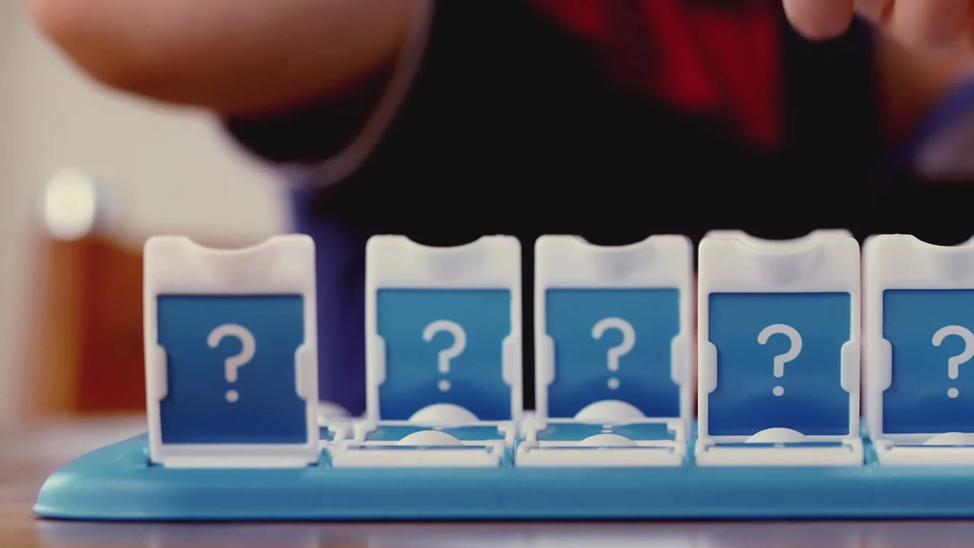 Close-up of a boy flipping down cards on the game board