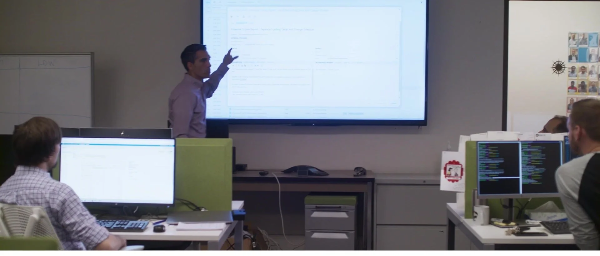 A team working through ideas at a screen
