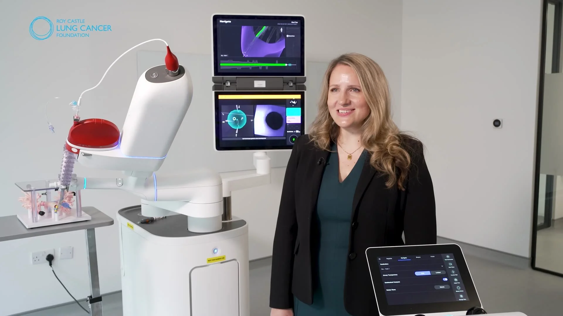 Stephanie Fraser beside the robotic bronchoscopy system