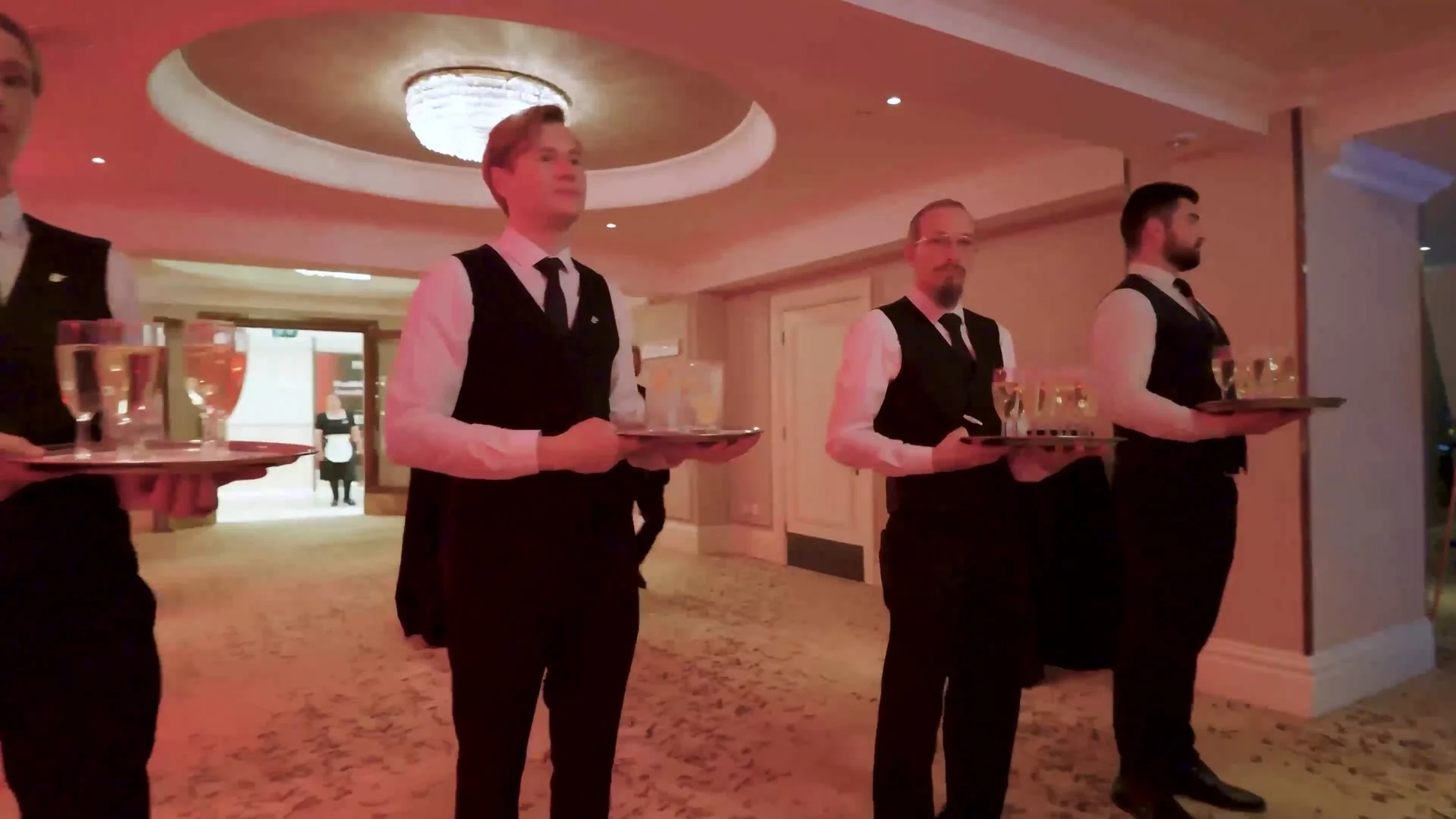 Waiting staff holding trays of drinks before the HealthInvestor Awards