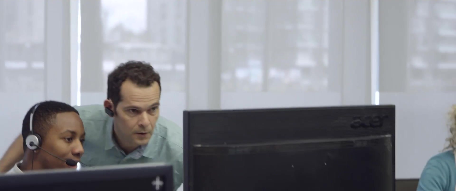 Advisers working together at their screens