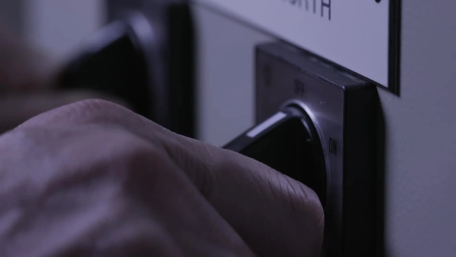 A hand turning the key to switch off the lights