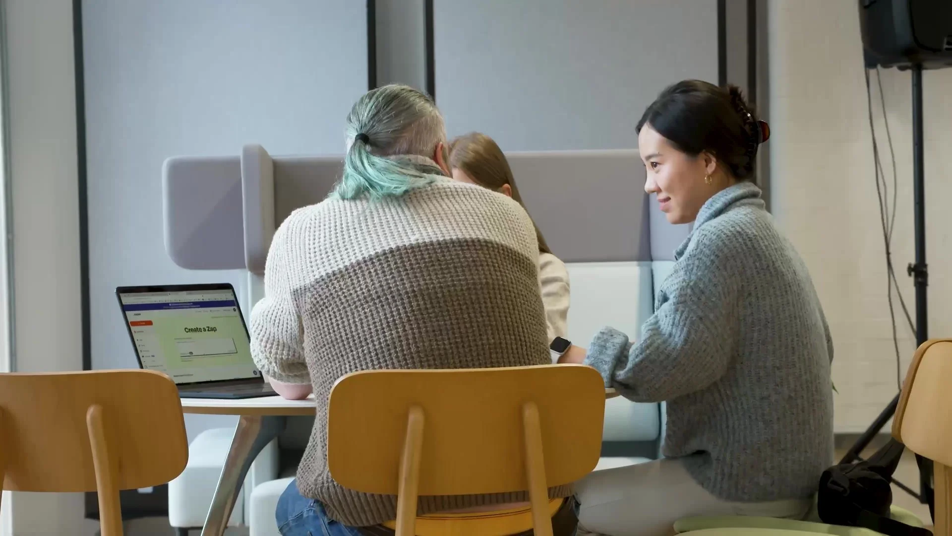 Attendees trying AI tools on laptops